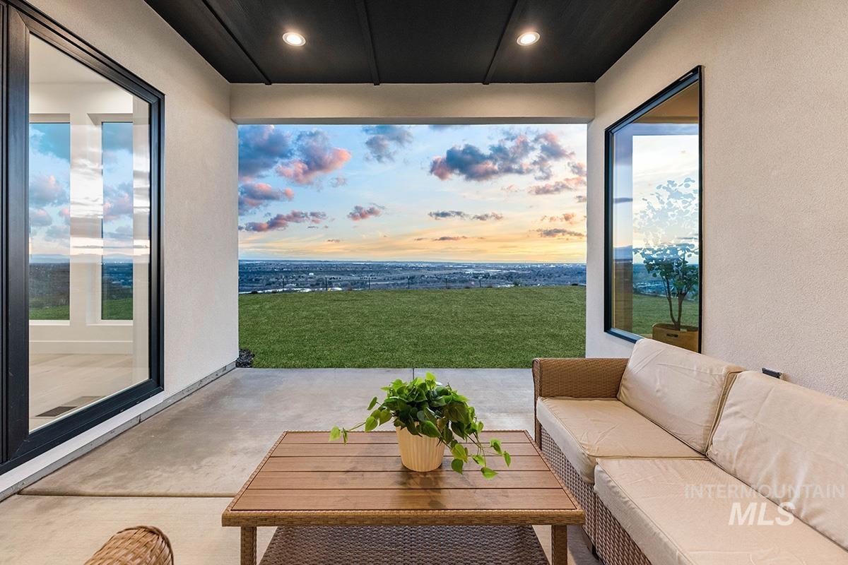 Patio terrace at dusk with a patio area, outdoor furniture, and a yard