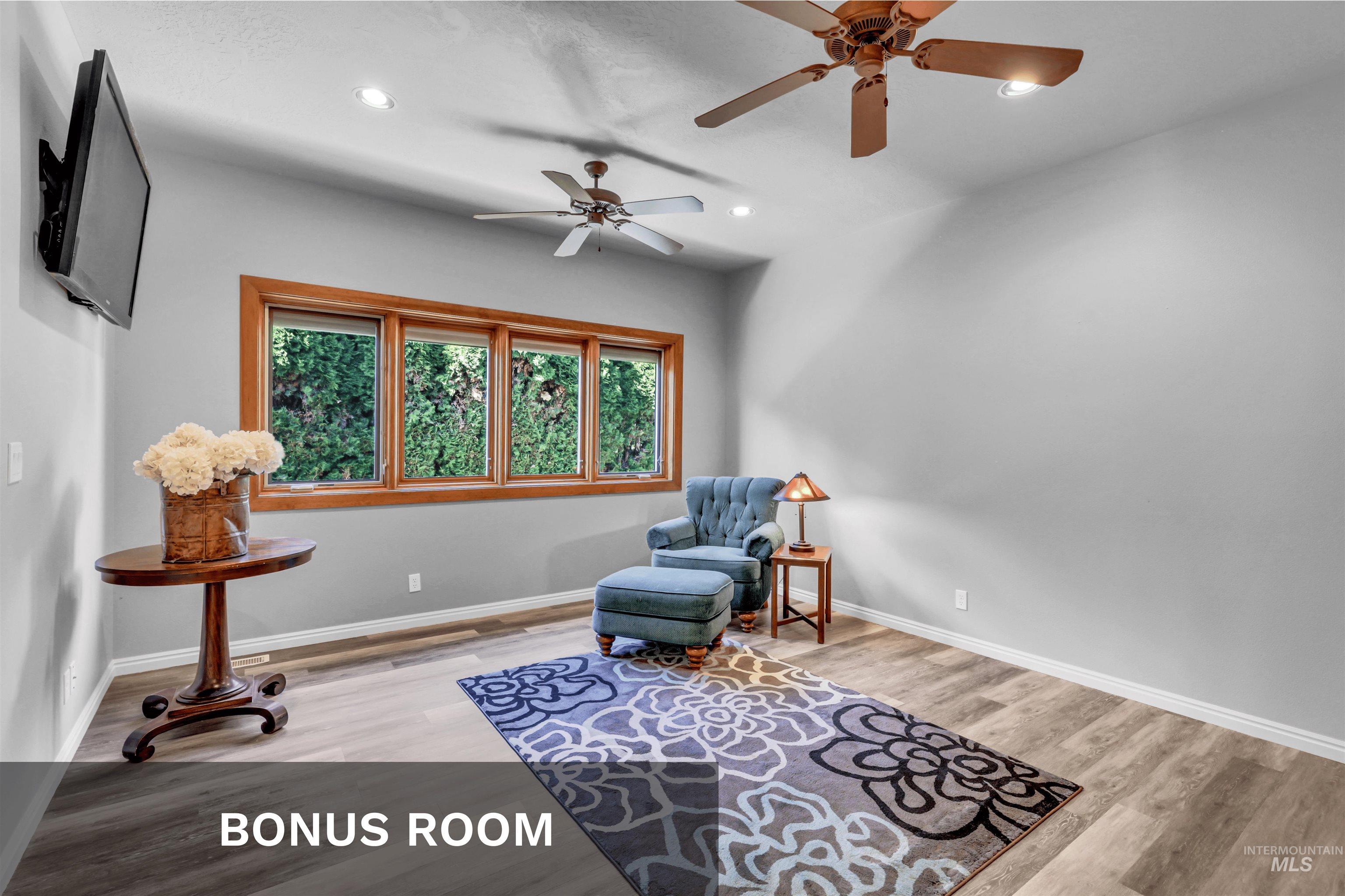 Living area featuring light wood-style flooring, recessed lighting, and ceiling fan
