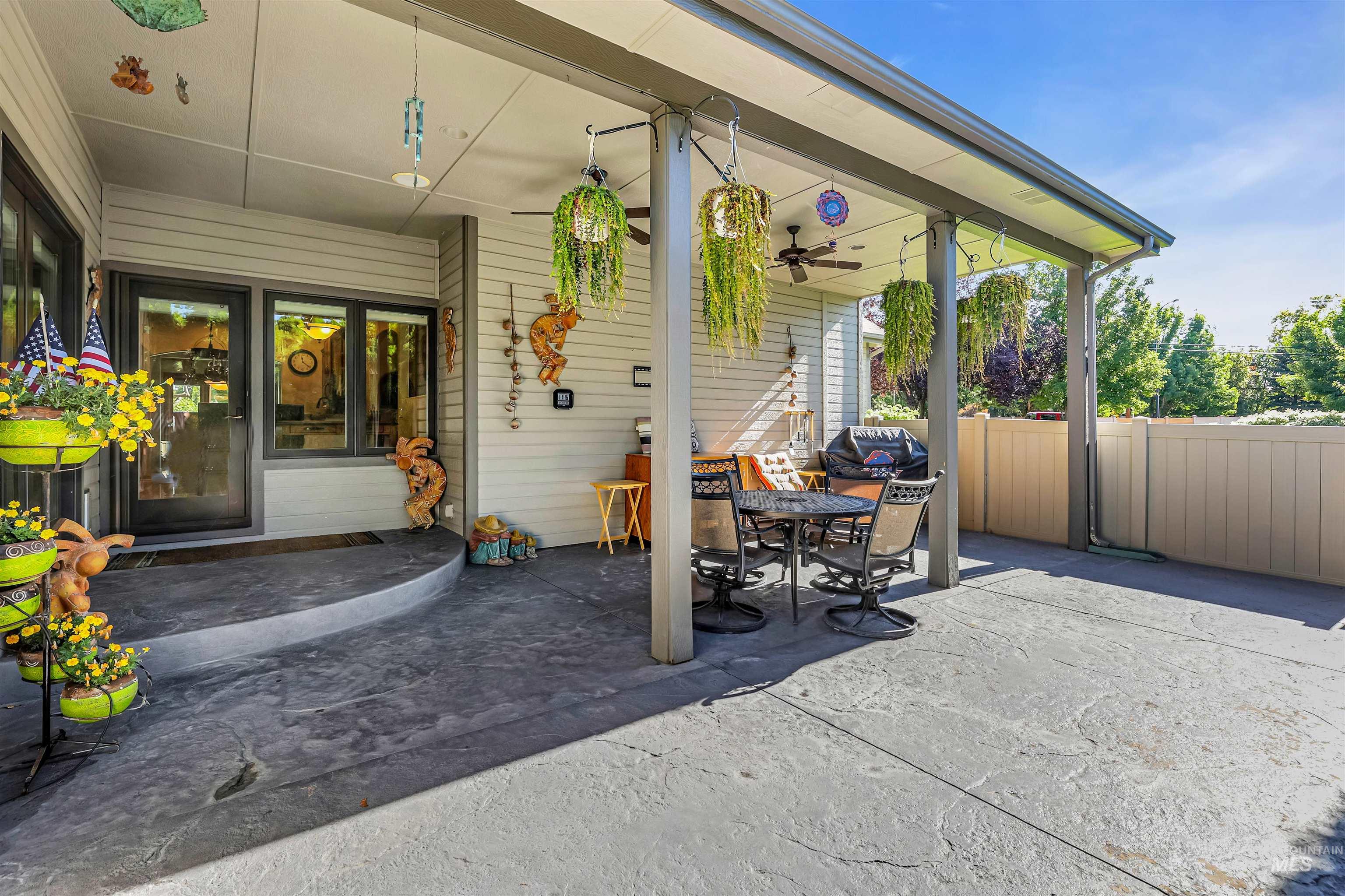 View of patio featuring a ceiling fan, outdoor dining space, and a grill