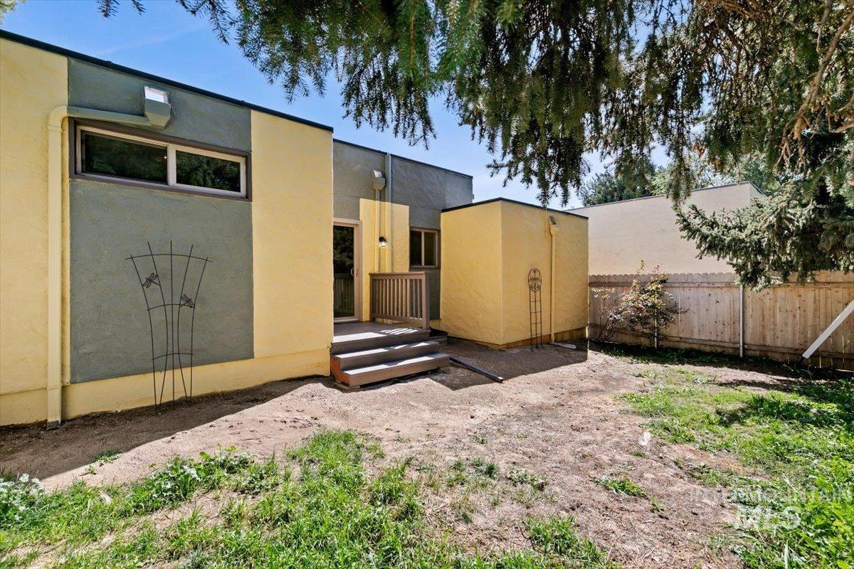 Rear view of house with stucco siding and a deck