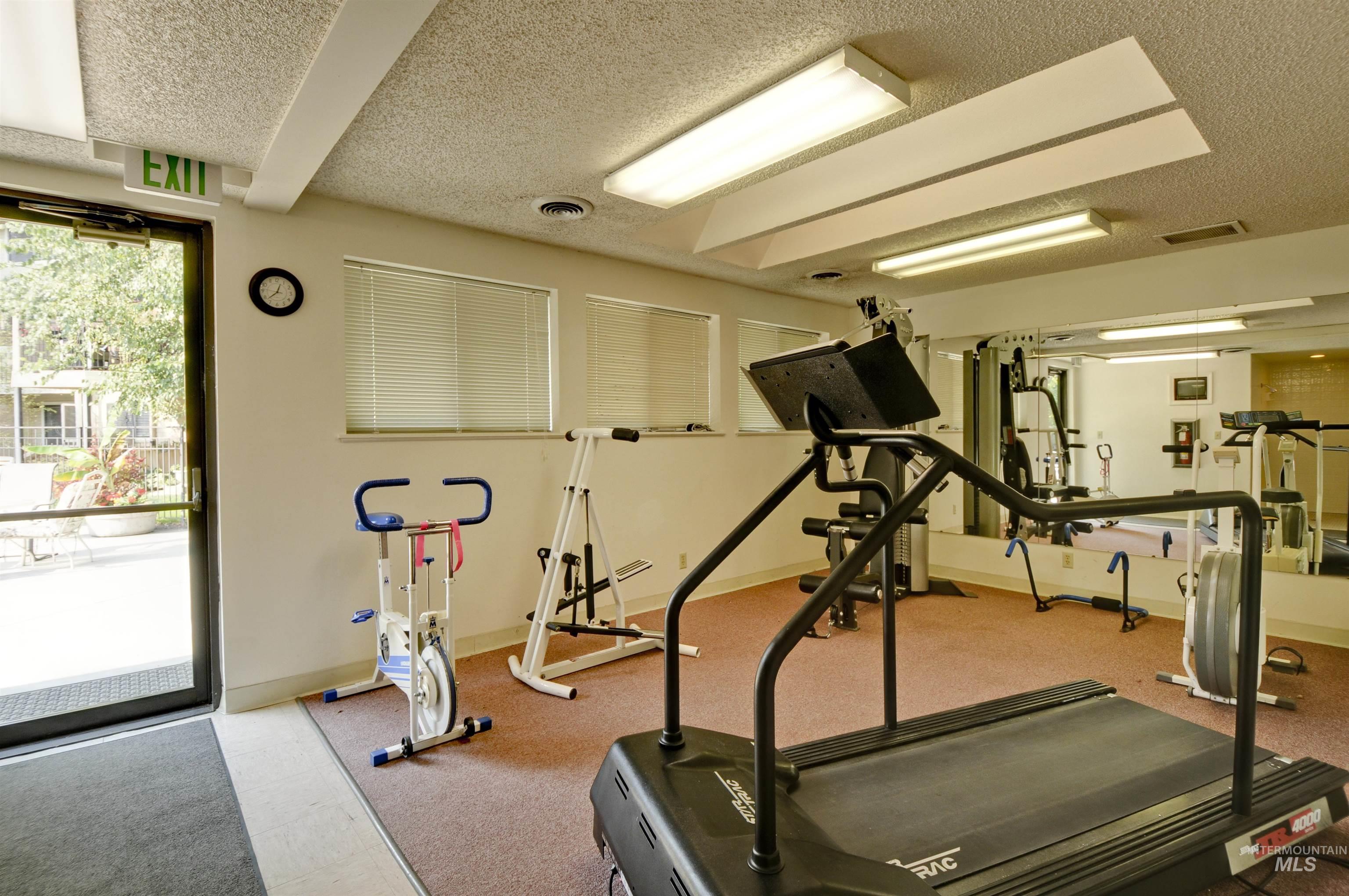 Workout room with a textured ceiling