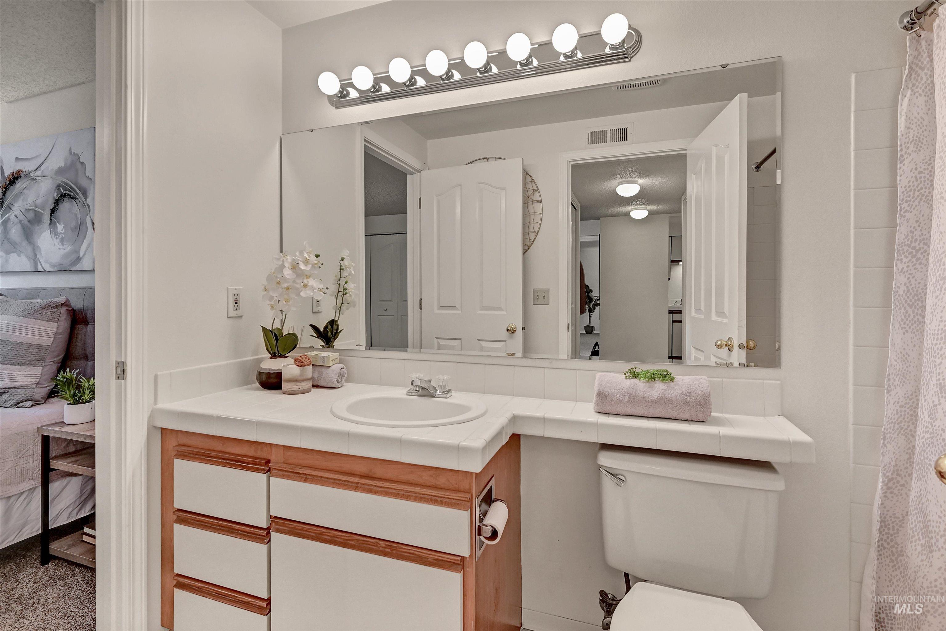 Bathroom with vanity, ensuite bathroom, and a shower with shower curtain