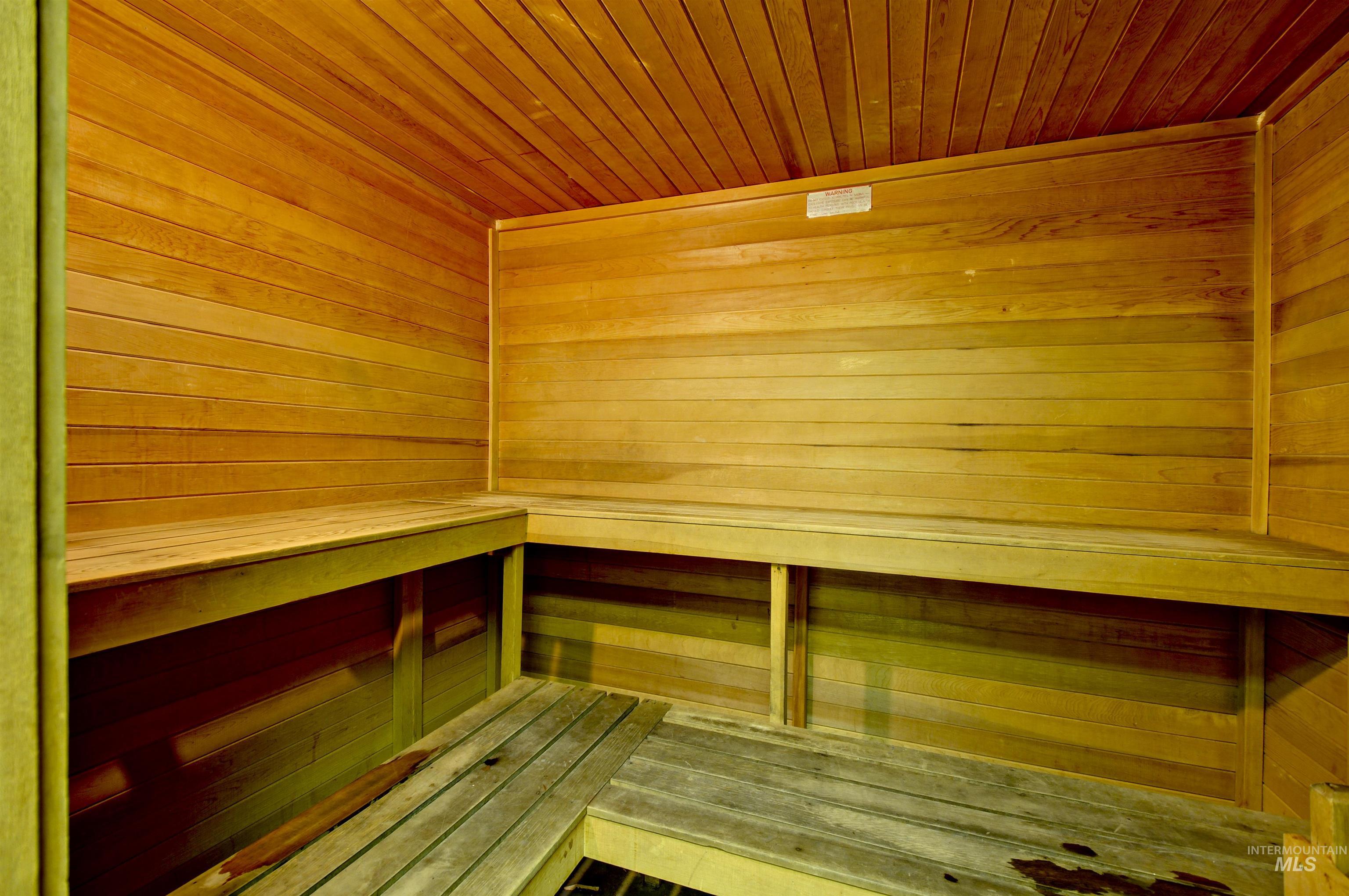 Relaxing sauna with wooden ceiling and wood walls