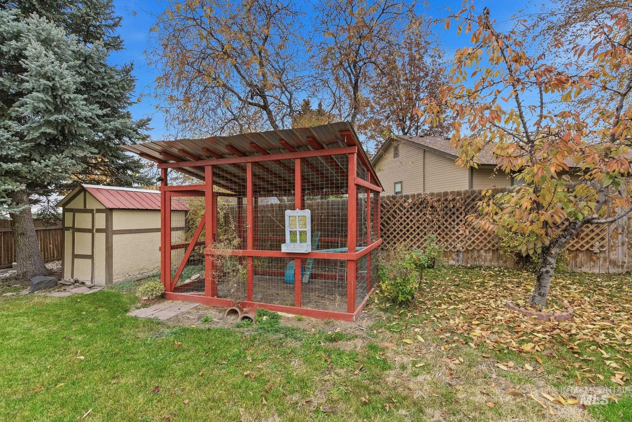 Fenced backyard with an outdoor structure and exterior structure