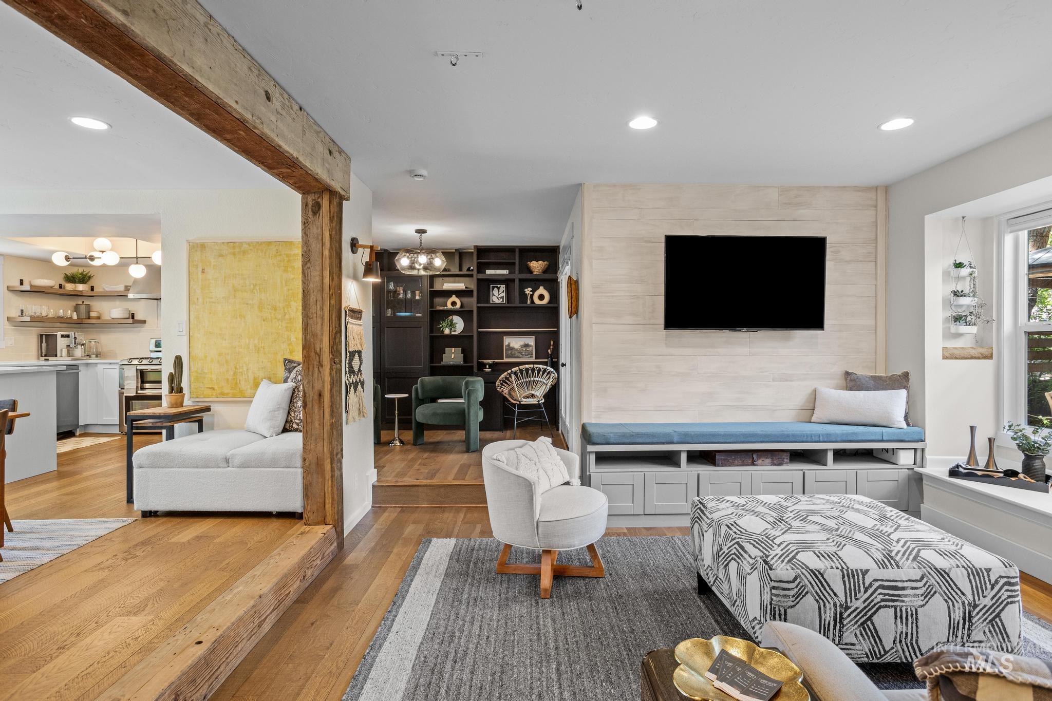 Living area featuring wood-finish flooring and a built-in media console with storage
