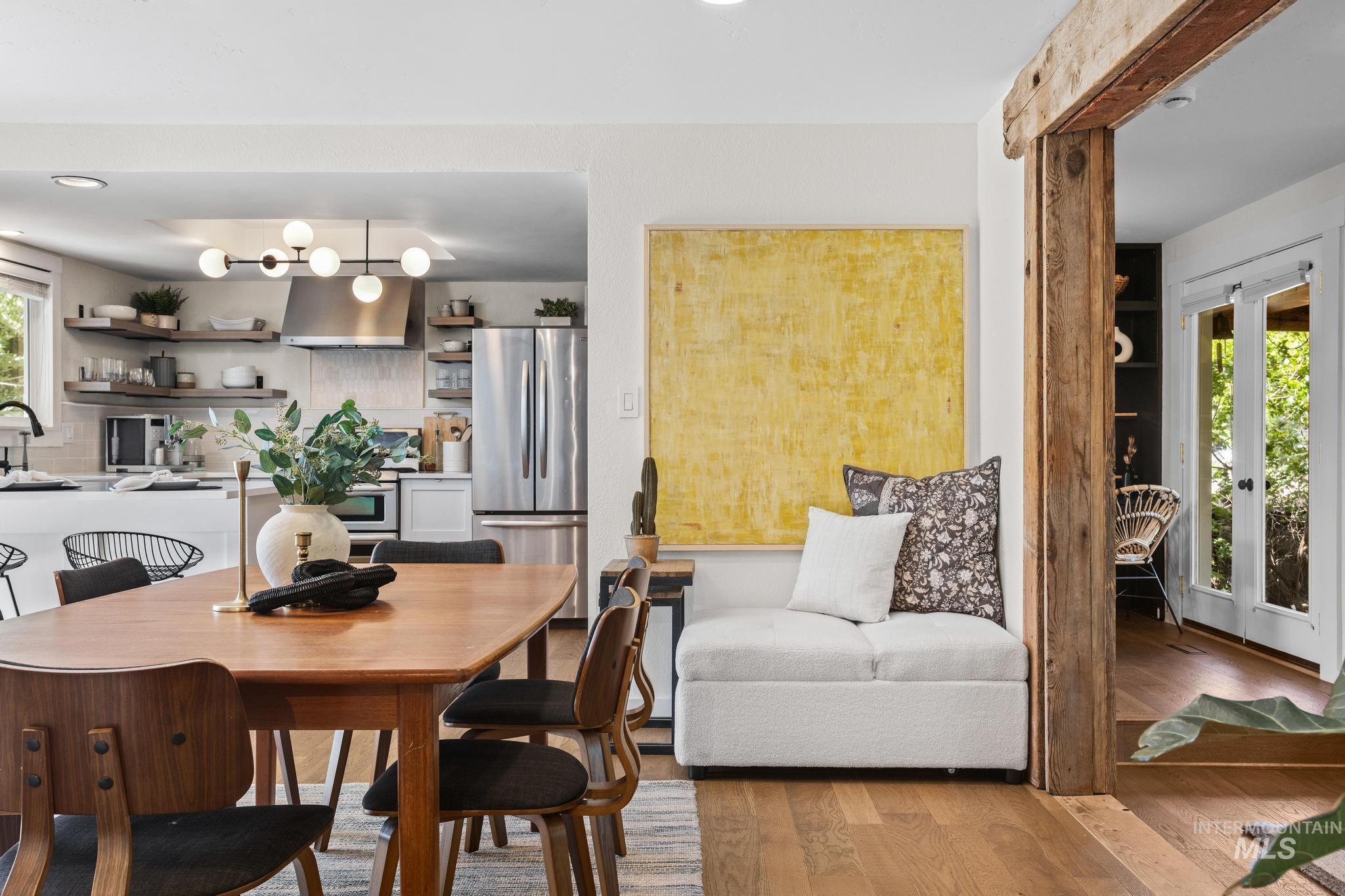 Dining area featuring wood-finish flooring, a wood dining table, and a built-in seating alcove