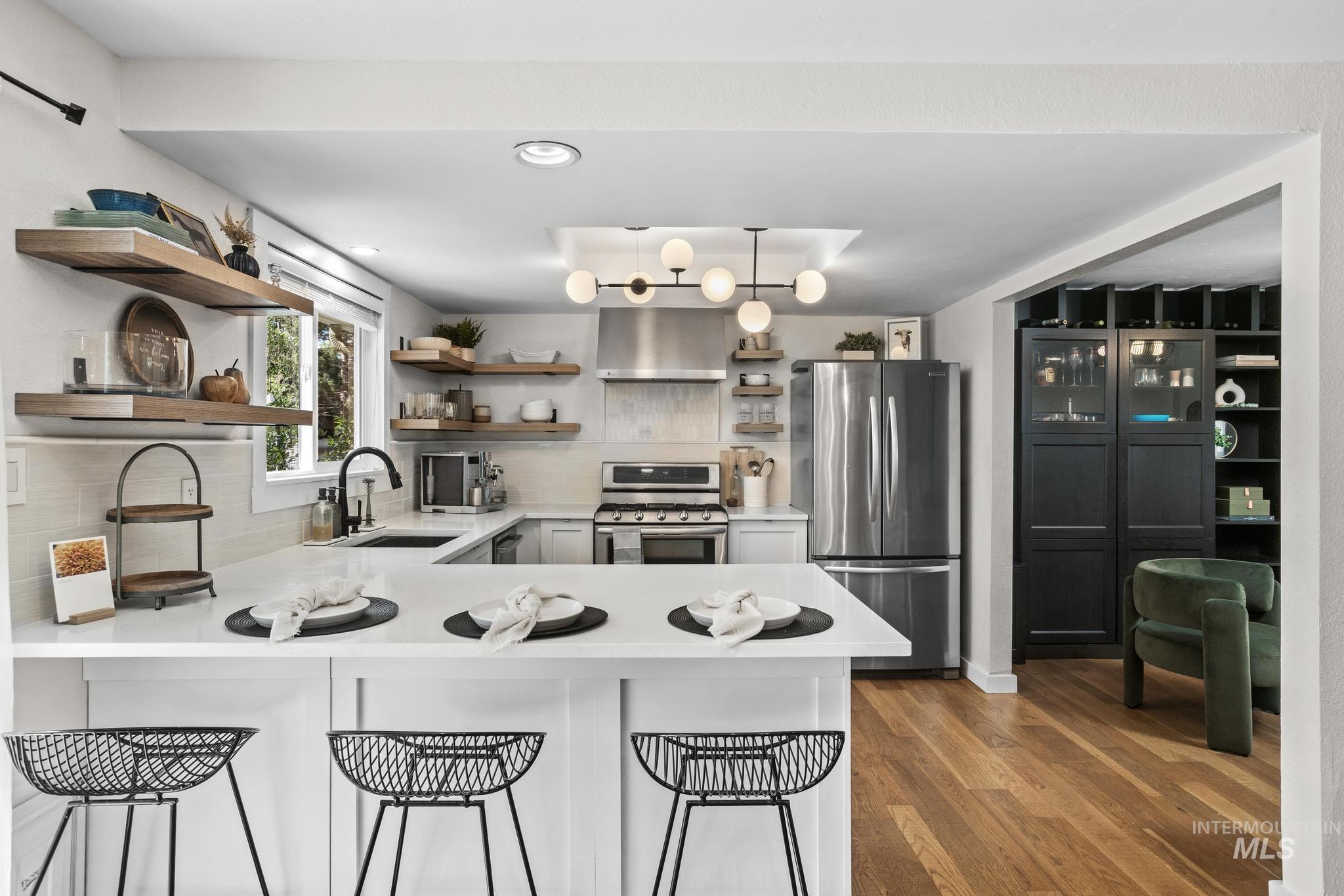 Contemporary kitchen with a spacious island featuring a white countertop and seating
