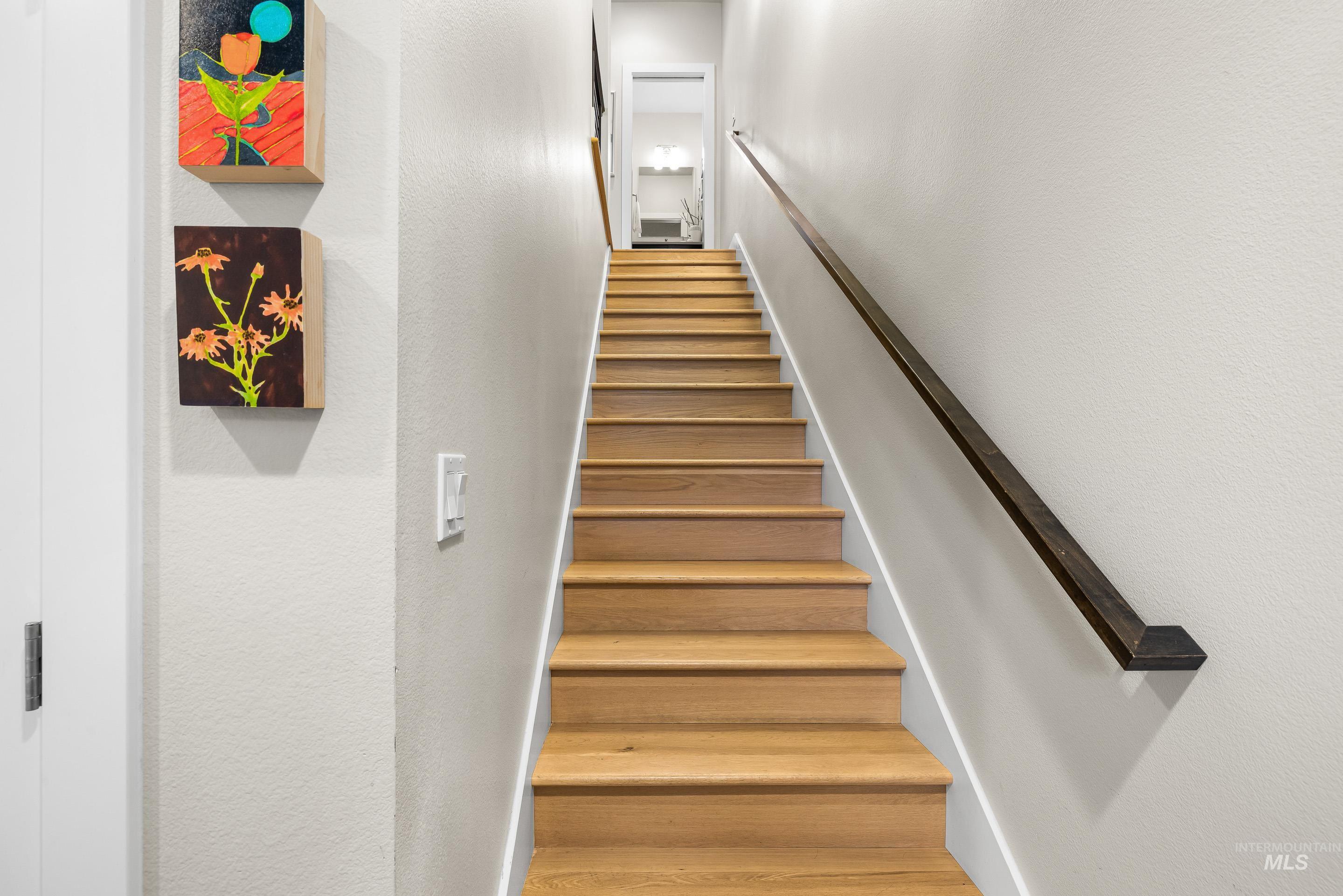 Staircase featuring a textured wall