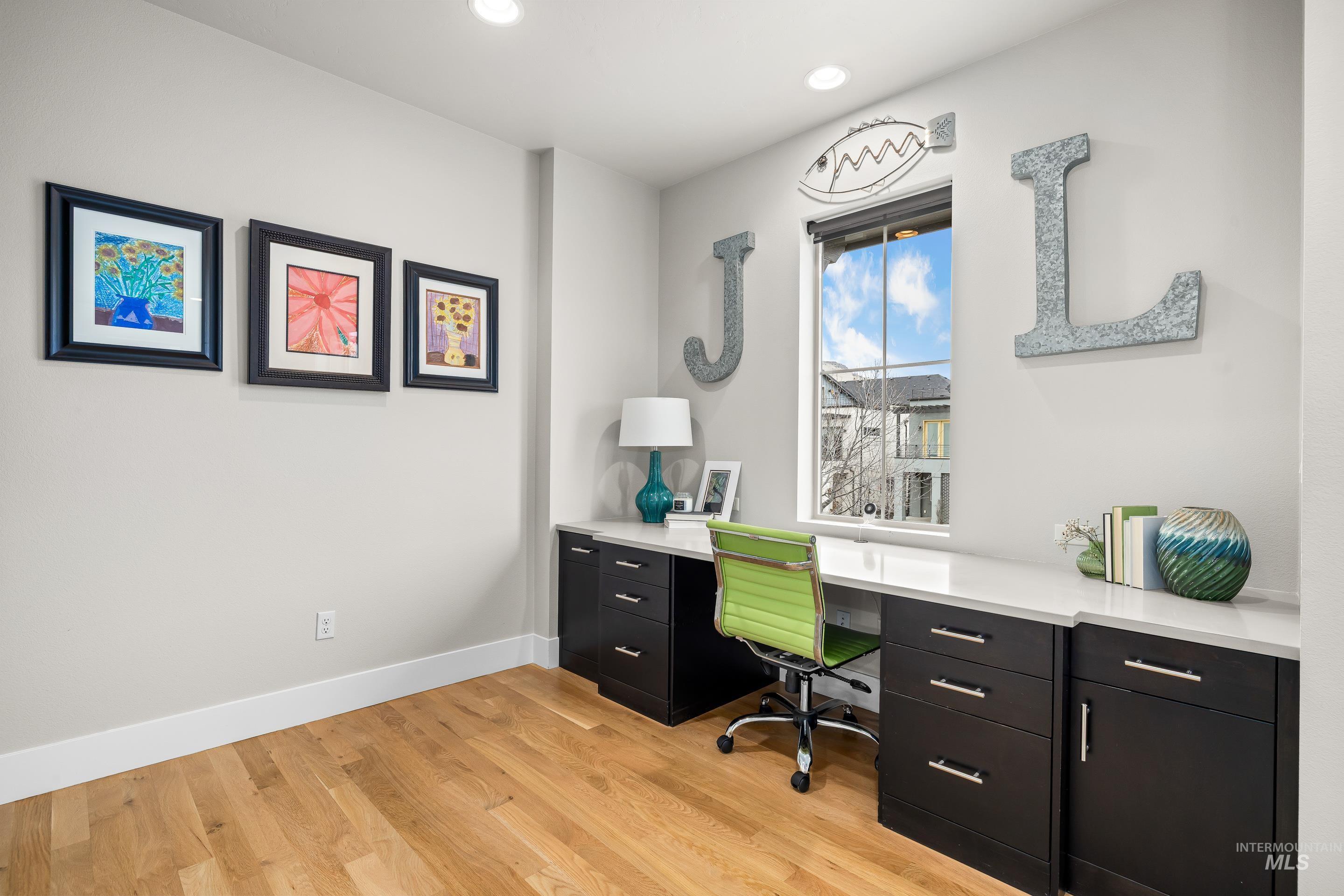 Office featuring light wood-style floors and recessed lighting