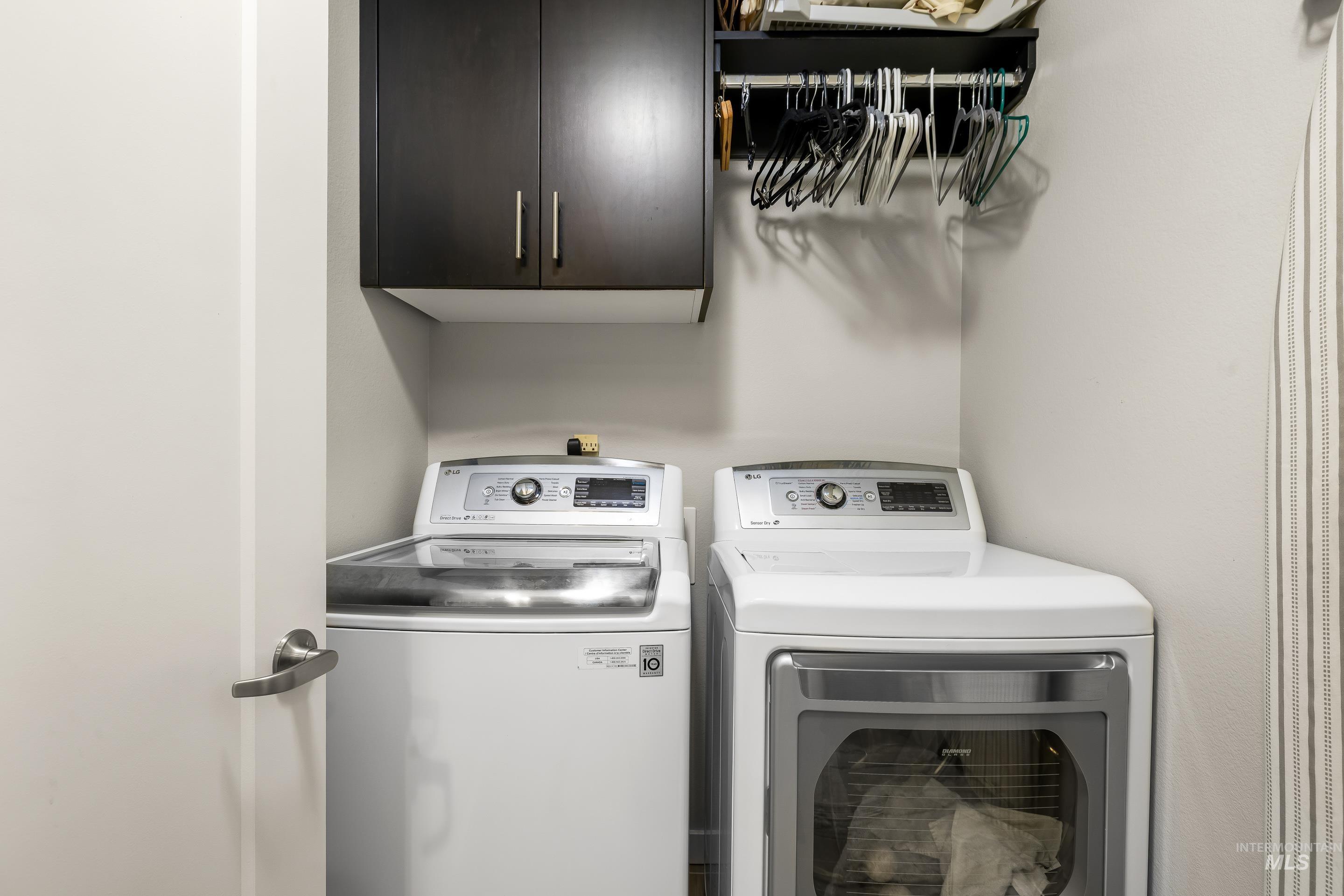 Laundry area featuring cabinet space and washer and dryer