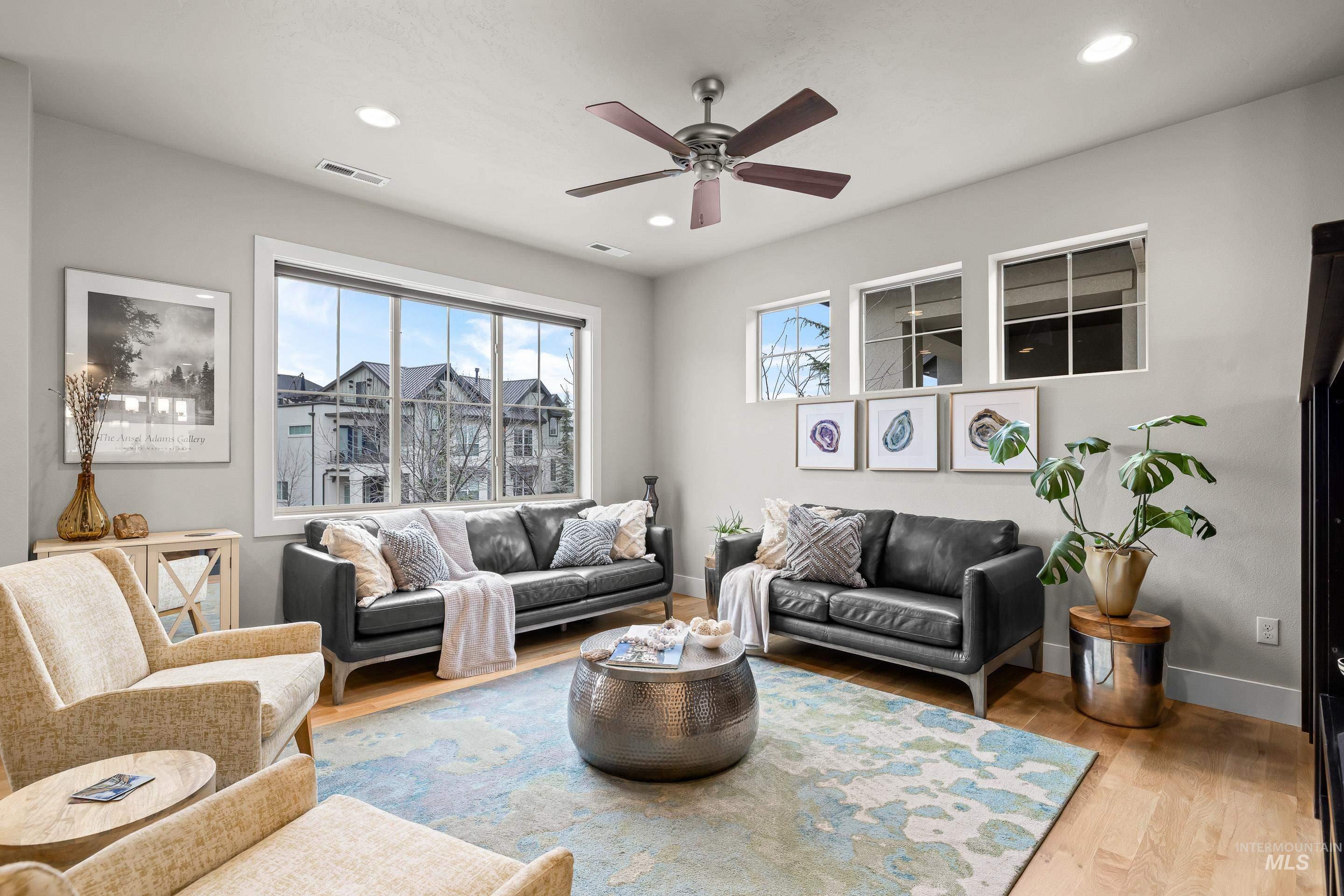 Living area featuring light wood-type flooring, ceiling fan, and recessed lighting