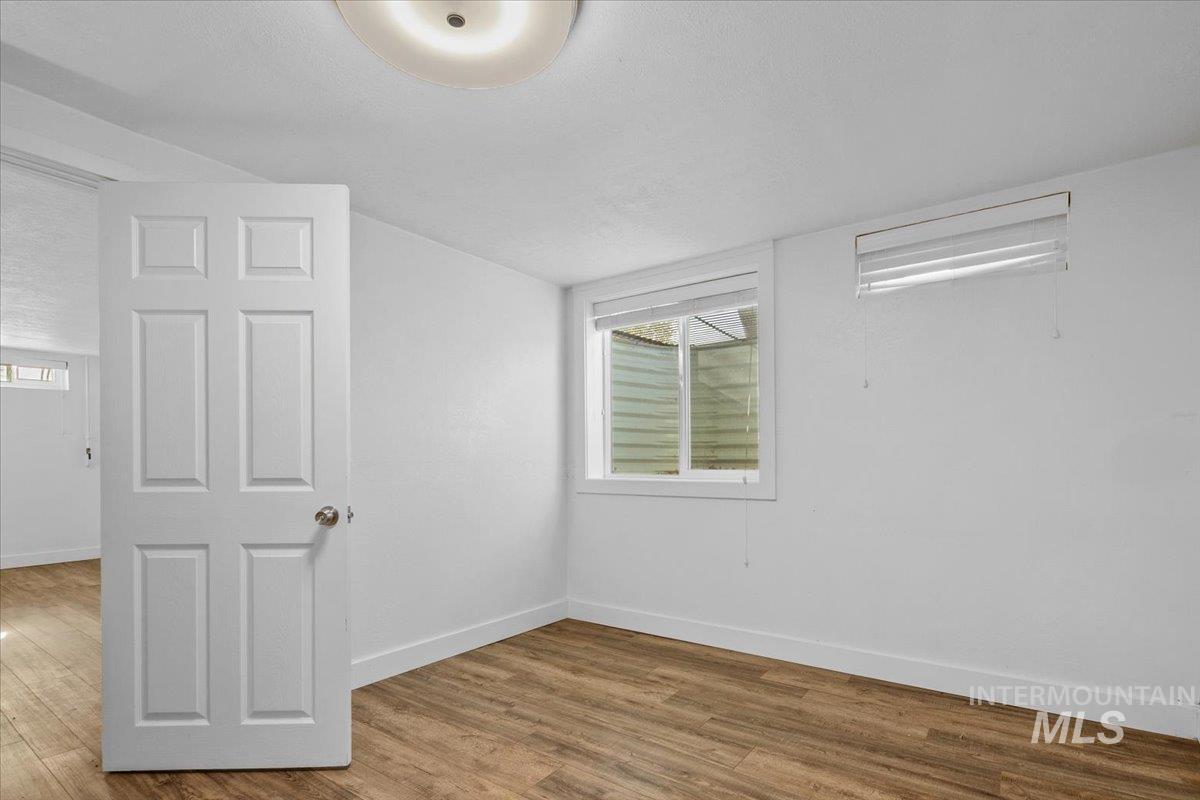 Spare room featuring wood finished floors