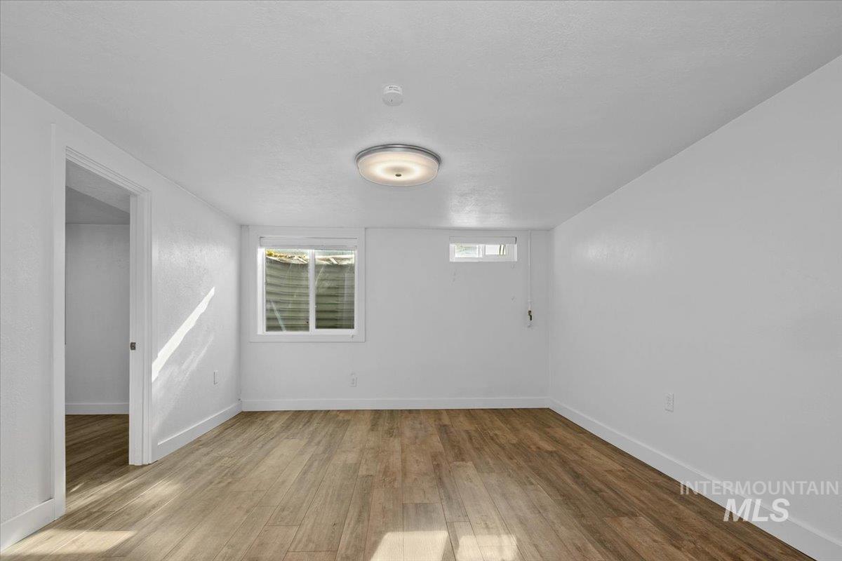 Spare room with light wood finished floors and baseboards