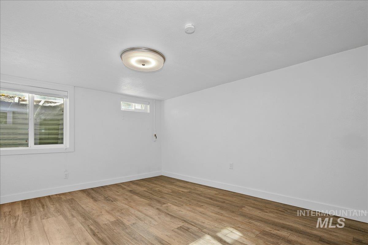 Empty room with wood finished floors and baseboards