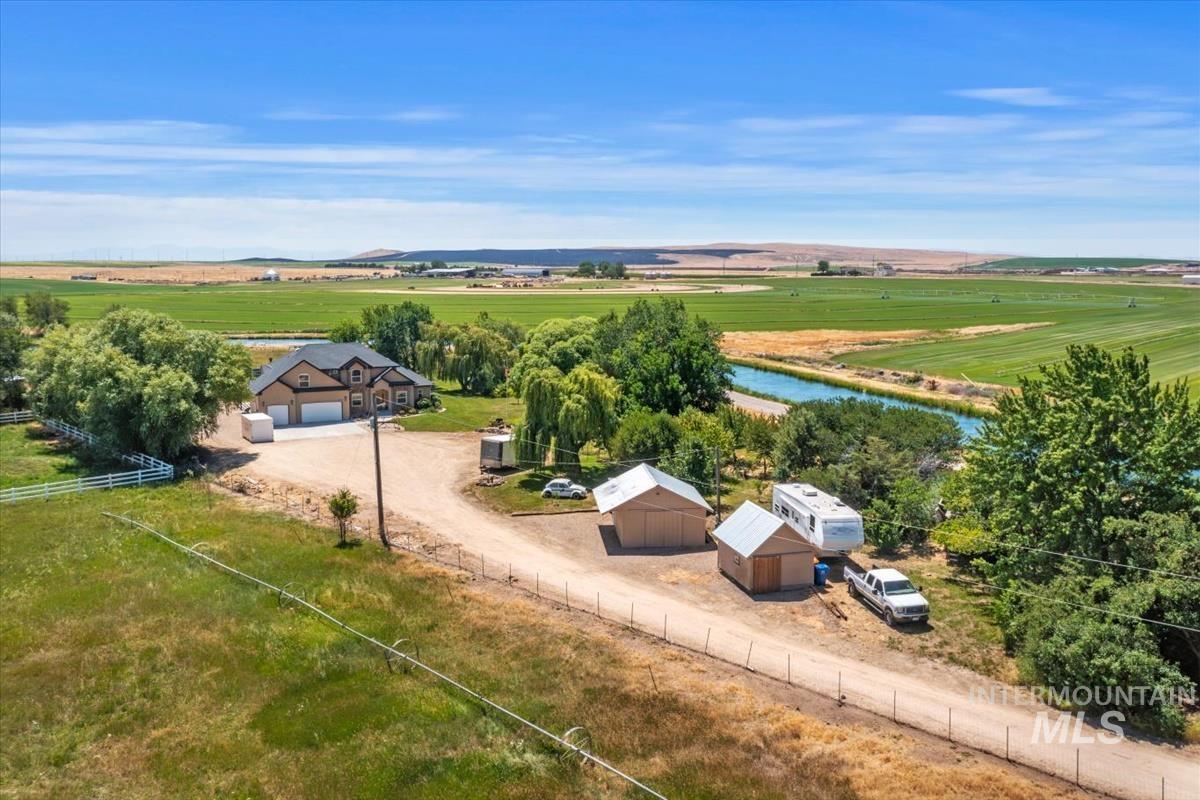 Expansive rural property featuring a two-story residence with an attached three-car garage