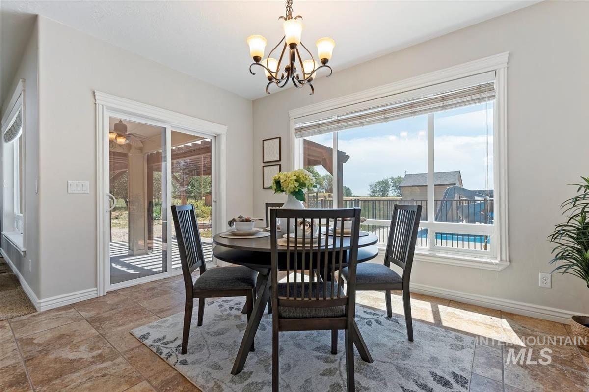 Dining area with tile flooring and a large window