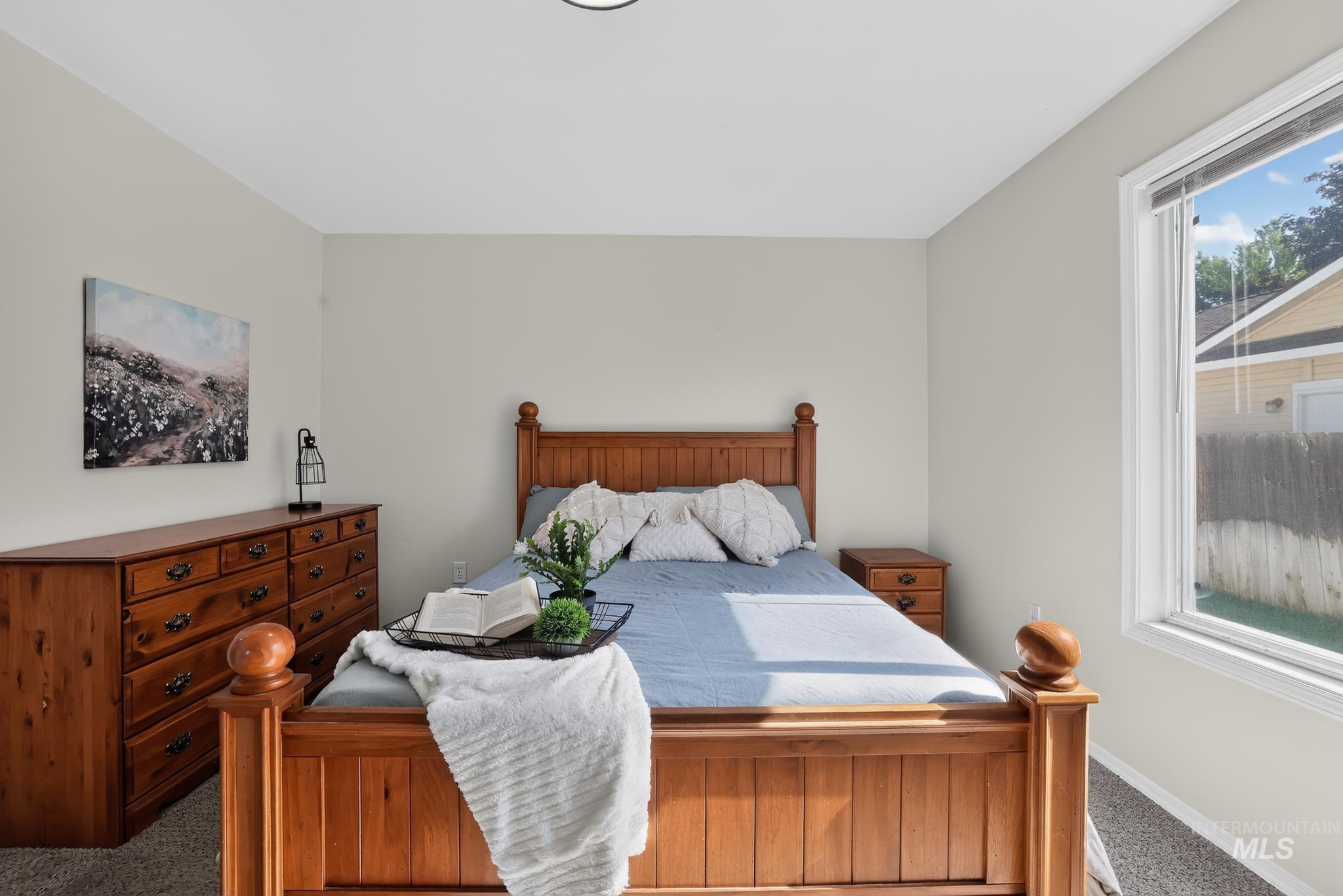Neutral-toned room with white trim, featuring carpeted flooring and an overhead flush-mount light fixture