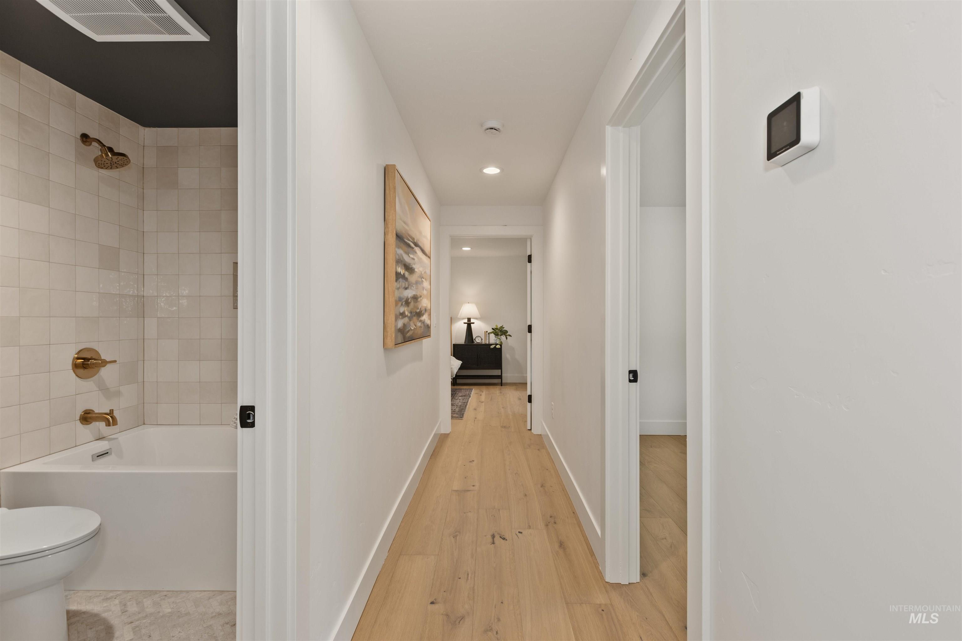 Hall with recessed lighting and light wood-type flooring