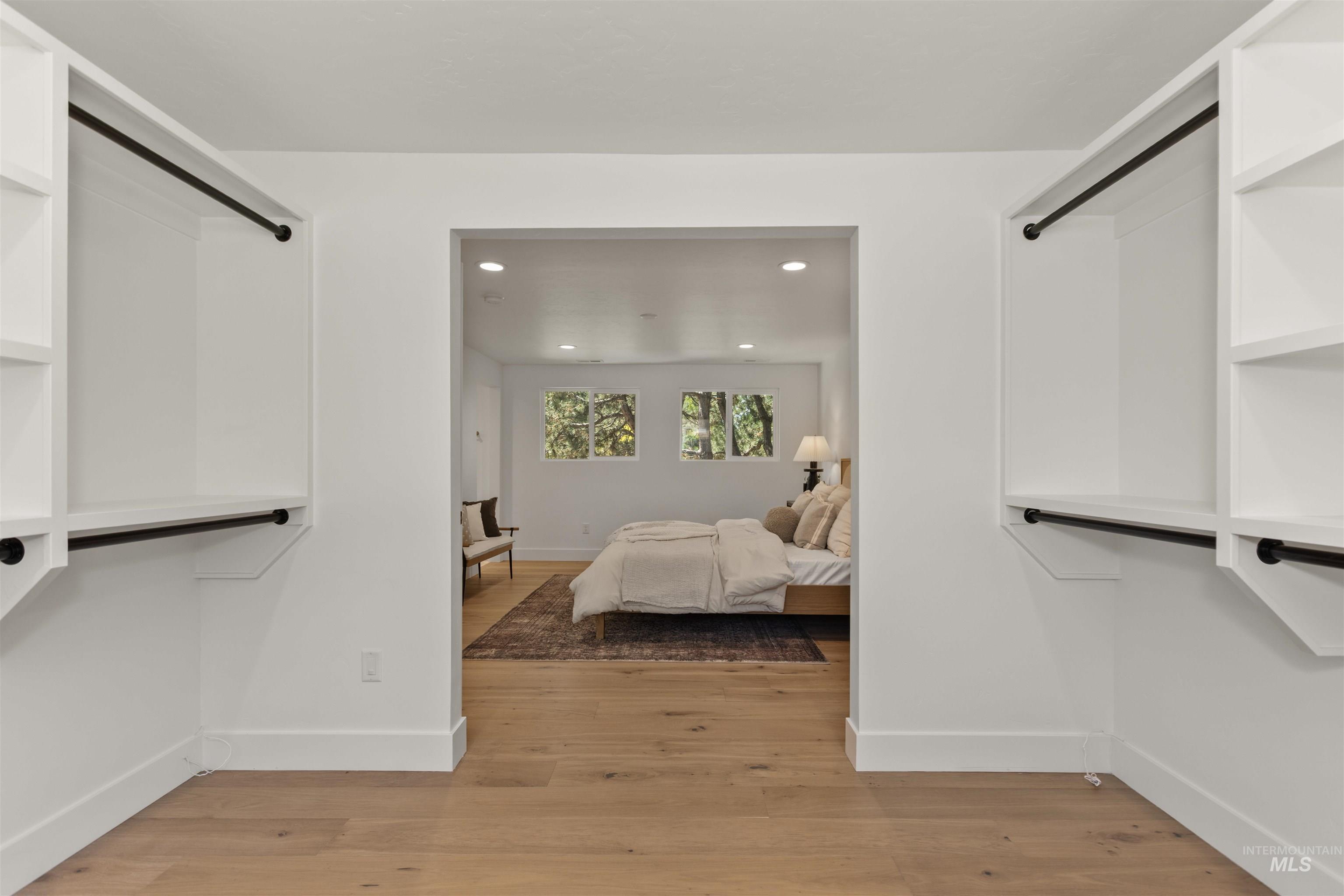 Spacious closet with light wood finished floors