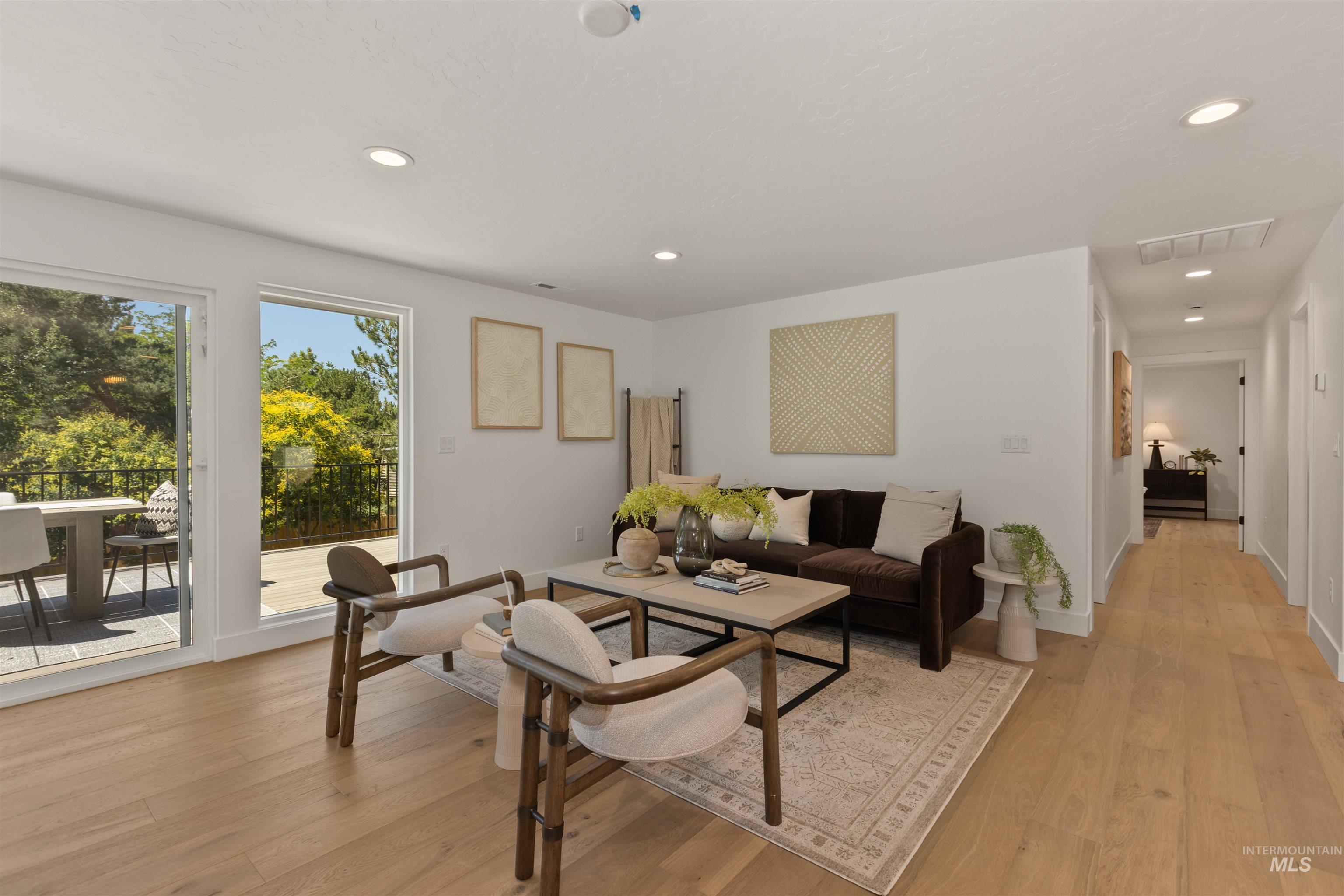 Living area featuring light wood-style floors and recessed lighting