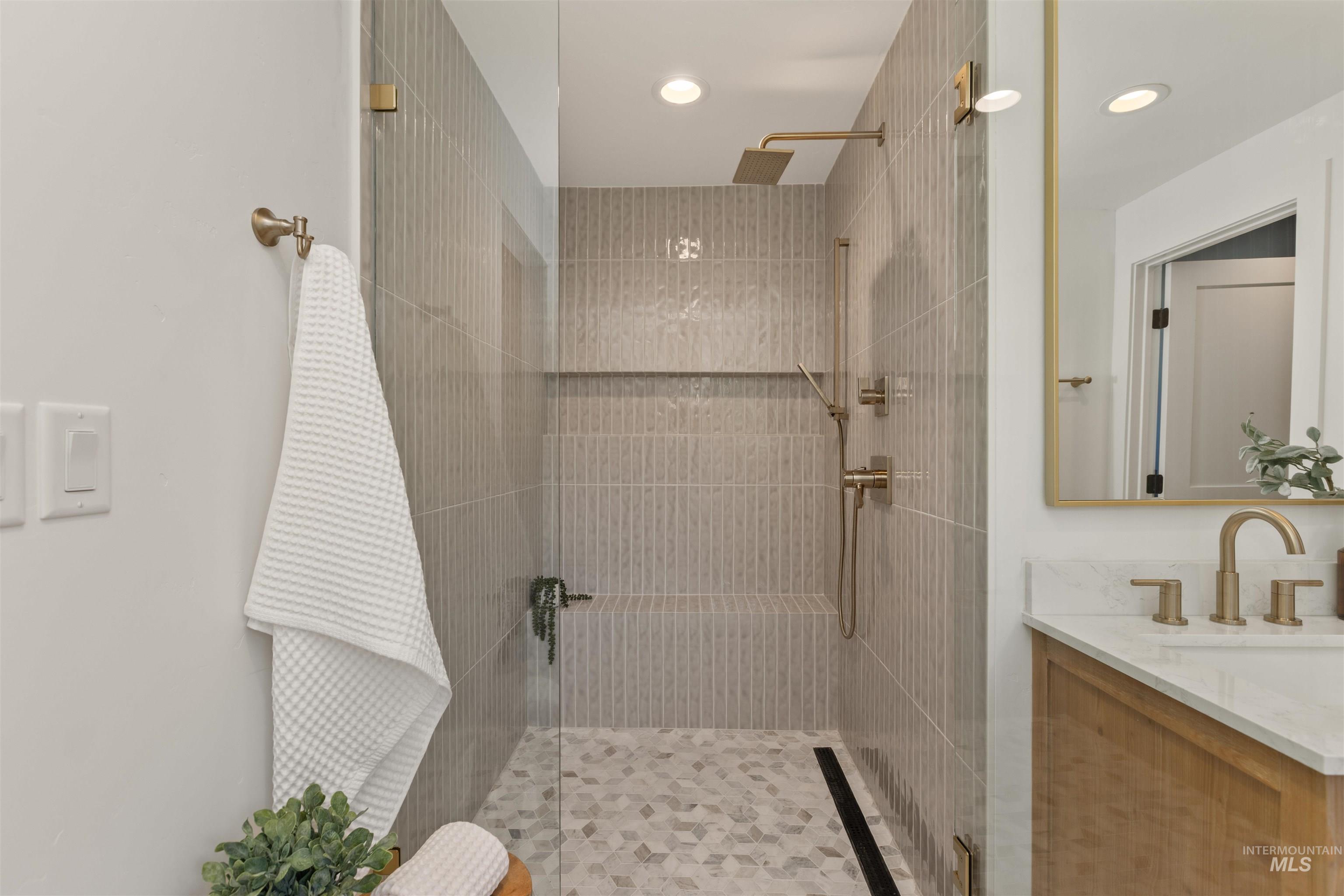 Full bathroom featuring a walk in shower, vanity, and recessed lighting