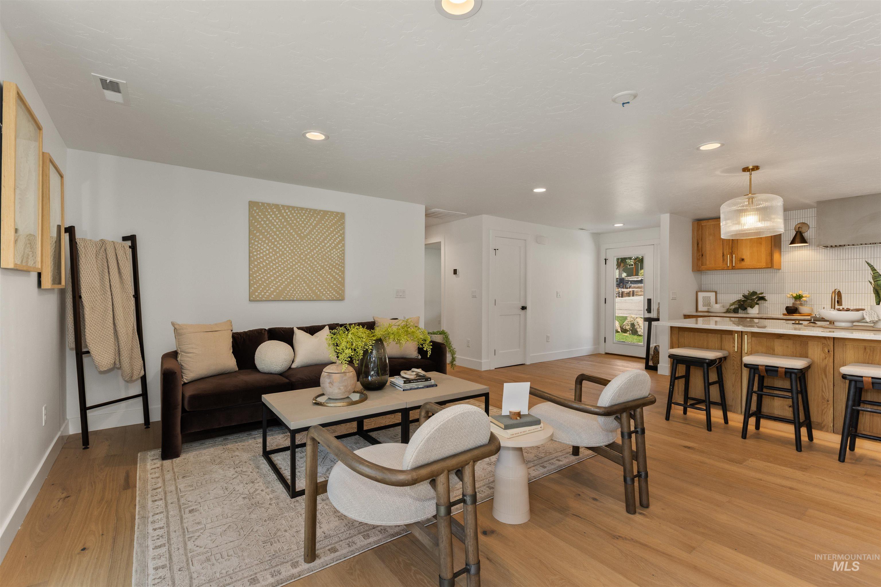 Living room featuring light wood finished floors and recessed lighting