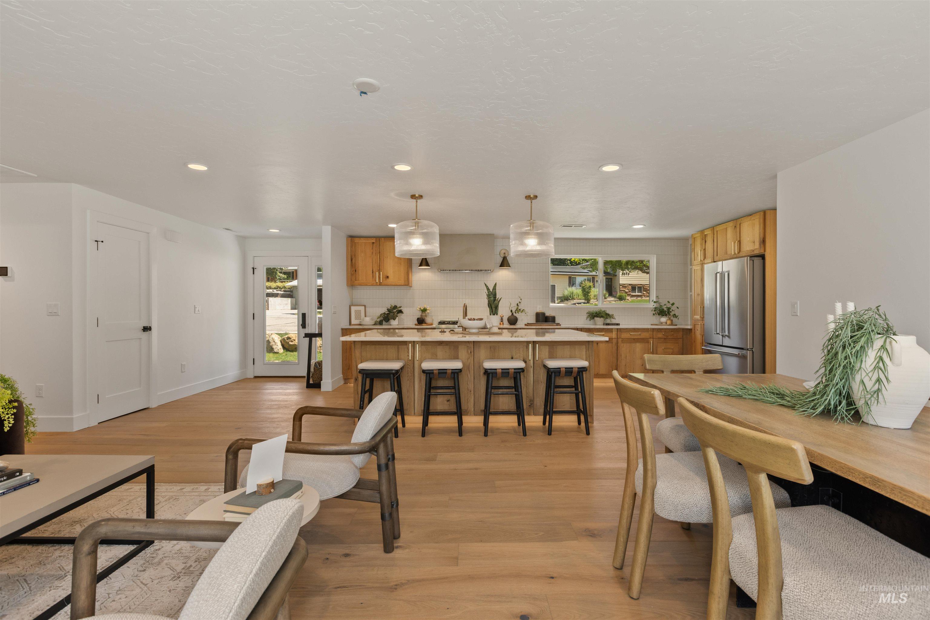 Dining area featuring light wood finished floors and recessed lighting