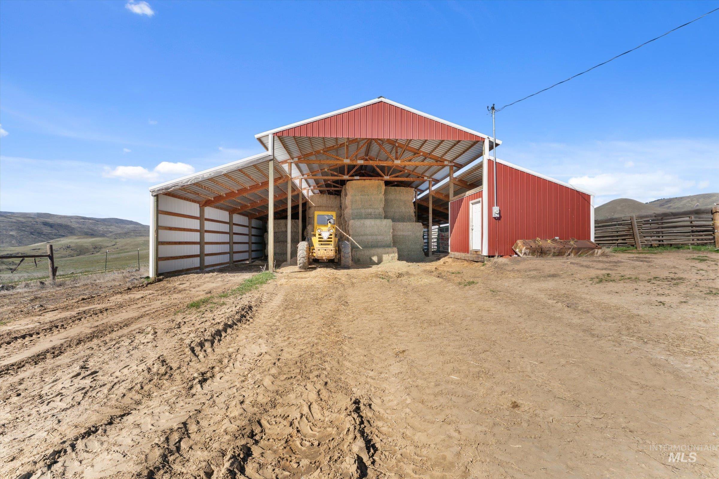 View of outbuilding featuring a mountain view, a view of rural / pastoral area, and a carport