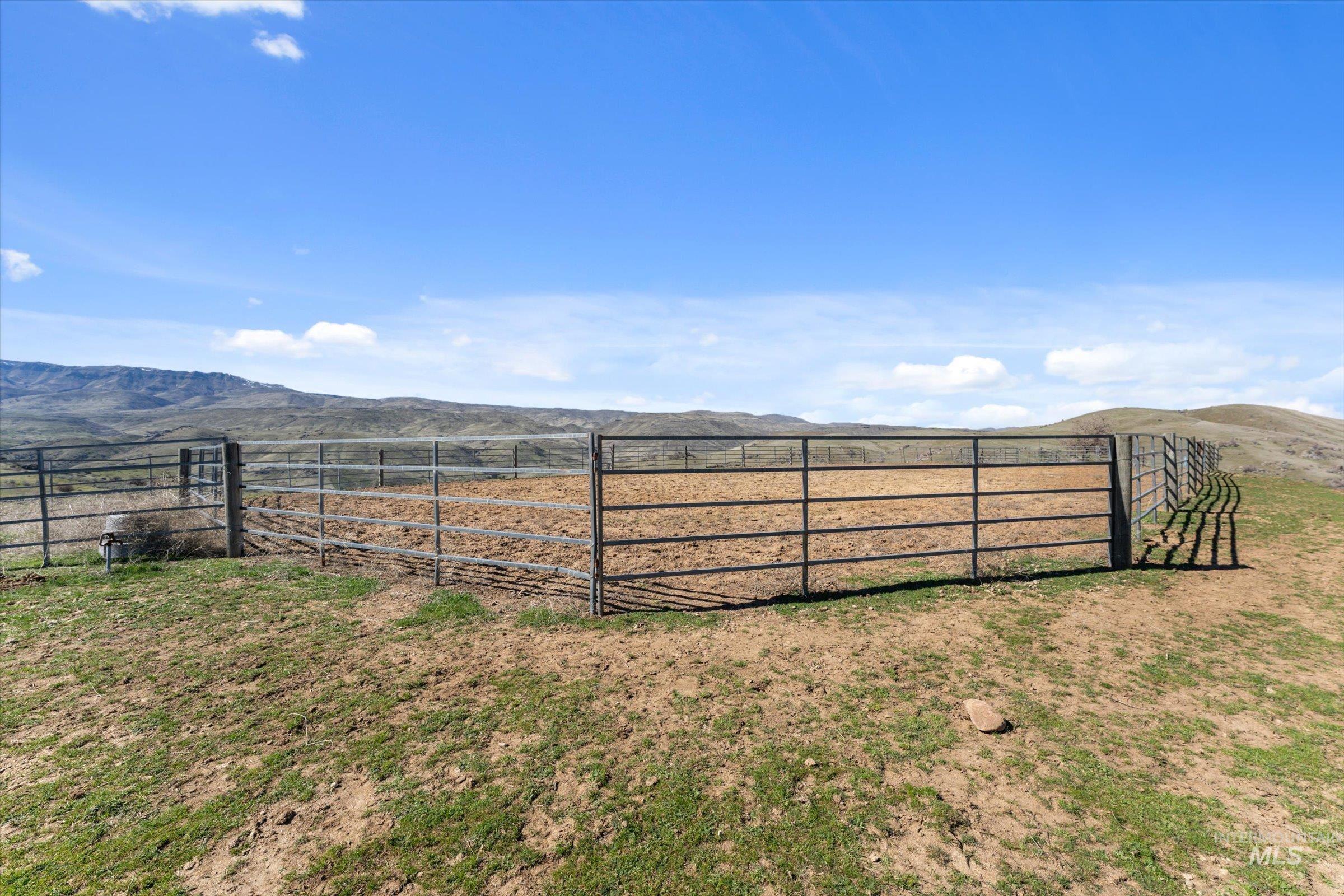 View of yard featuring a mountain view, a view of rural / pastoral area, and an outdoor riding arena