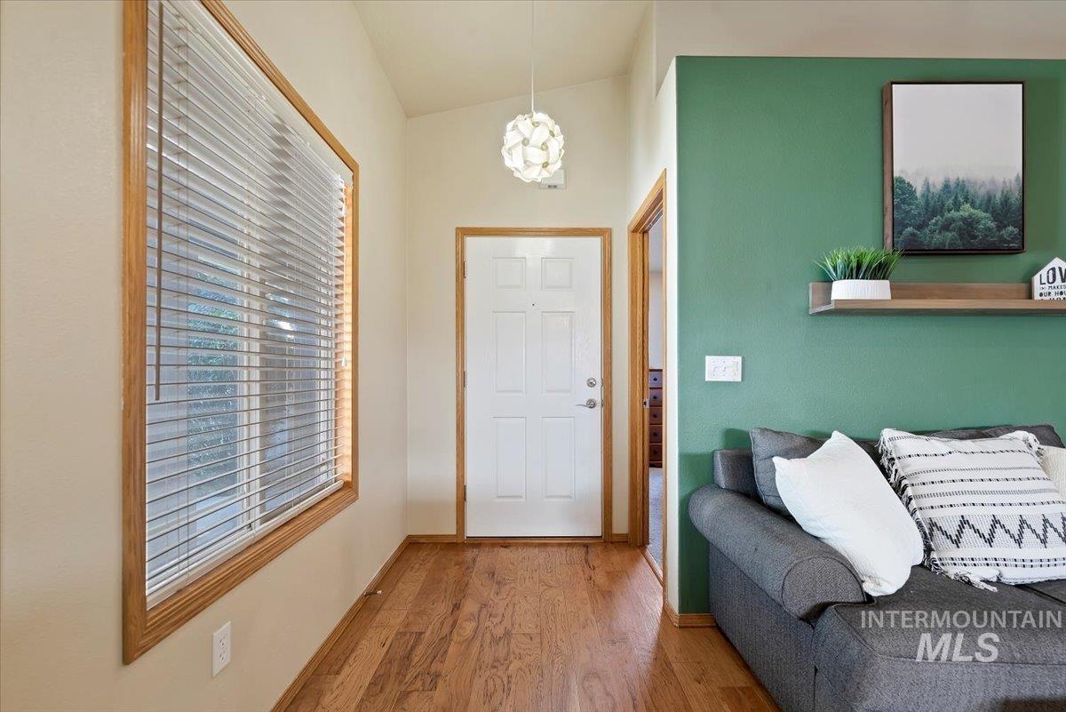 Entryway featuring wood finished floors and baseboards