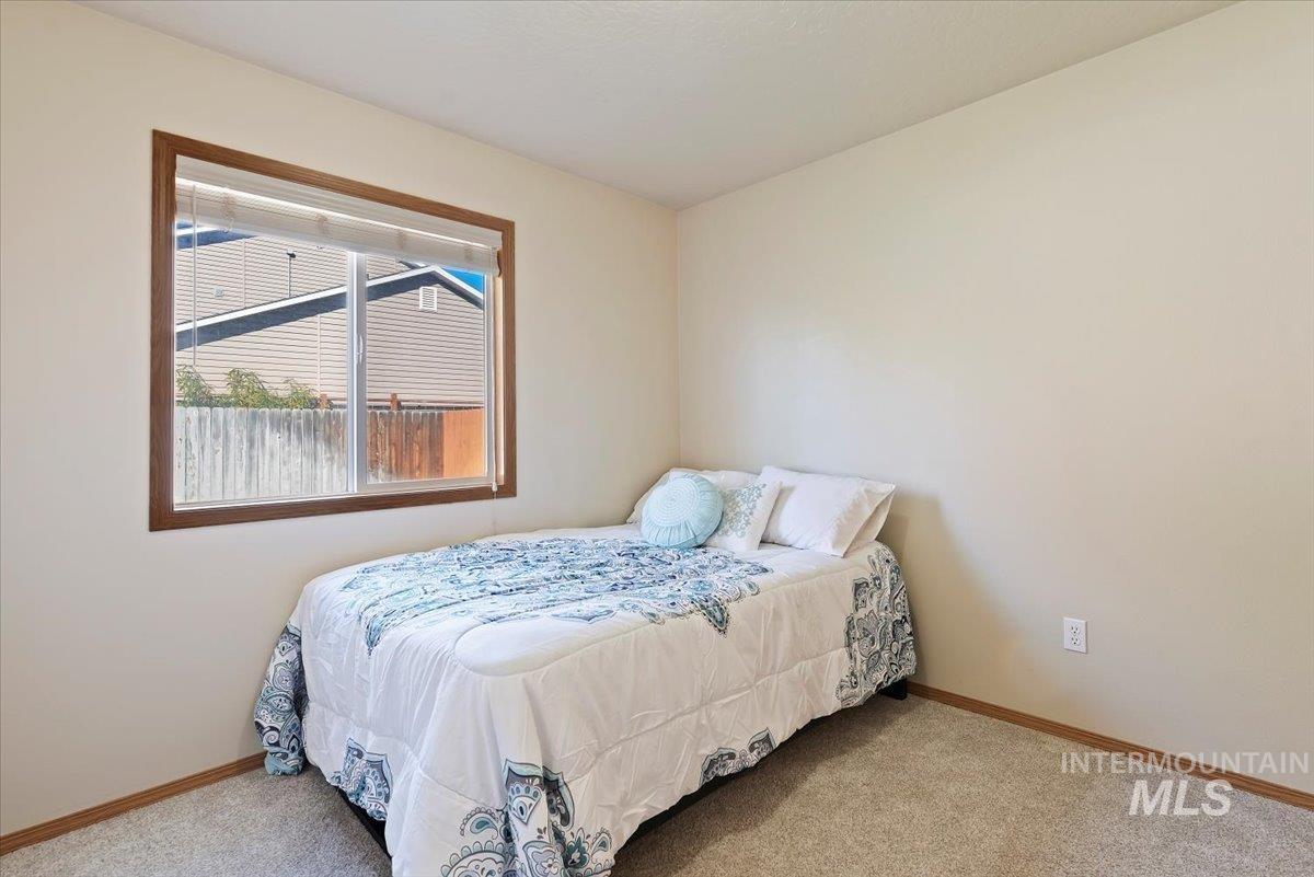 Bedroom with carpet and baseboards