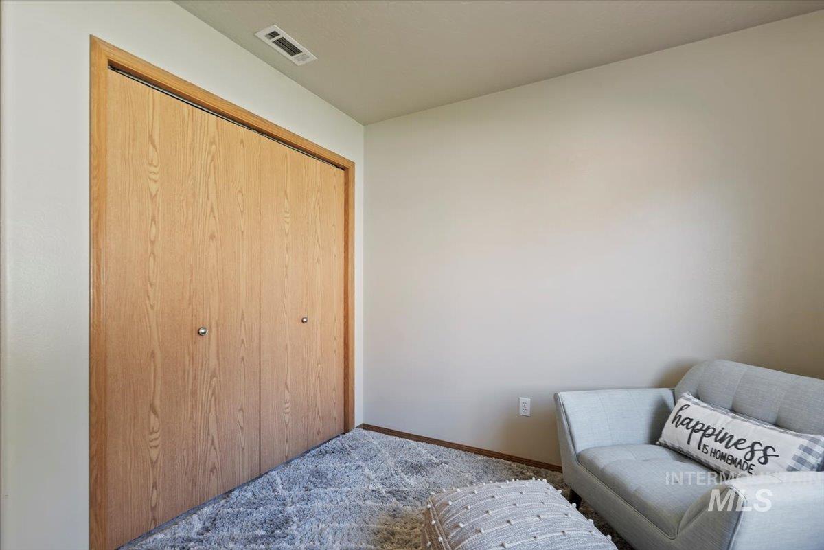 Sitting room featuring carpet floors and baseboards