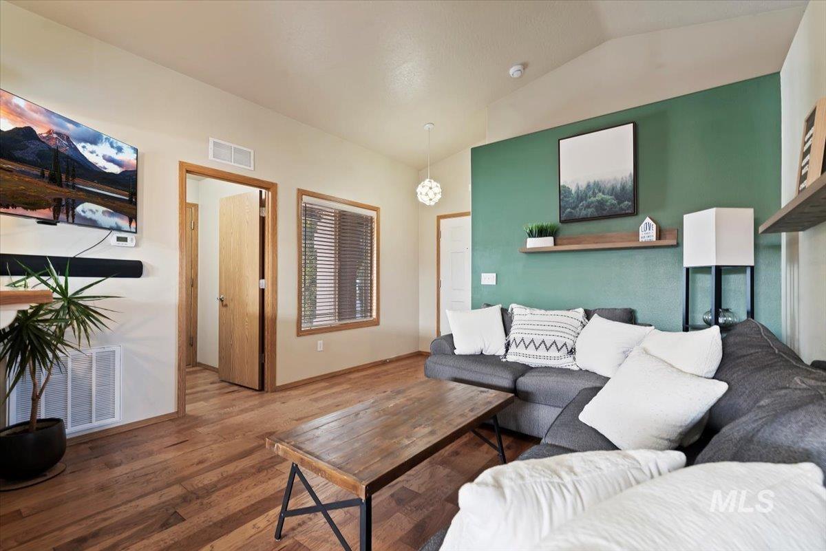 Living room featuring wood finished floors and lofted ceiling