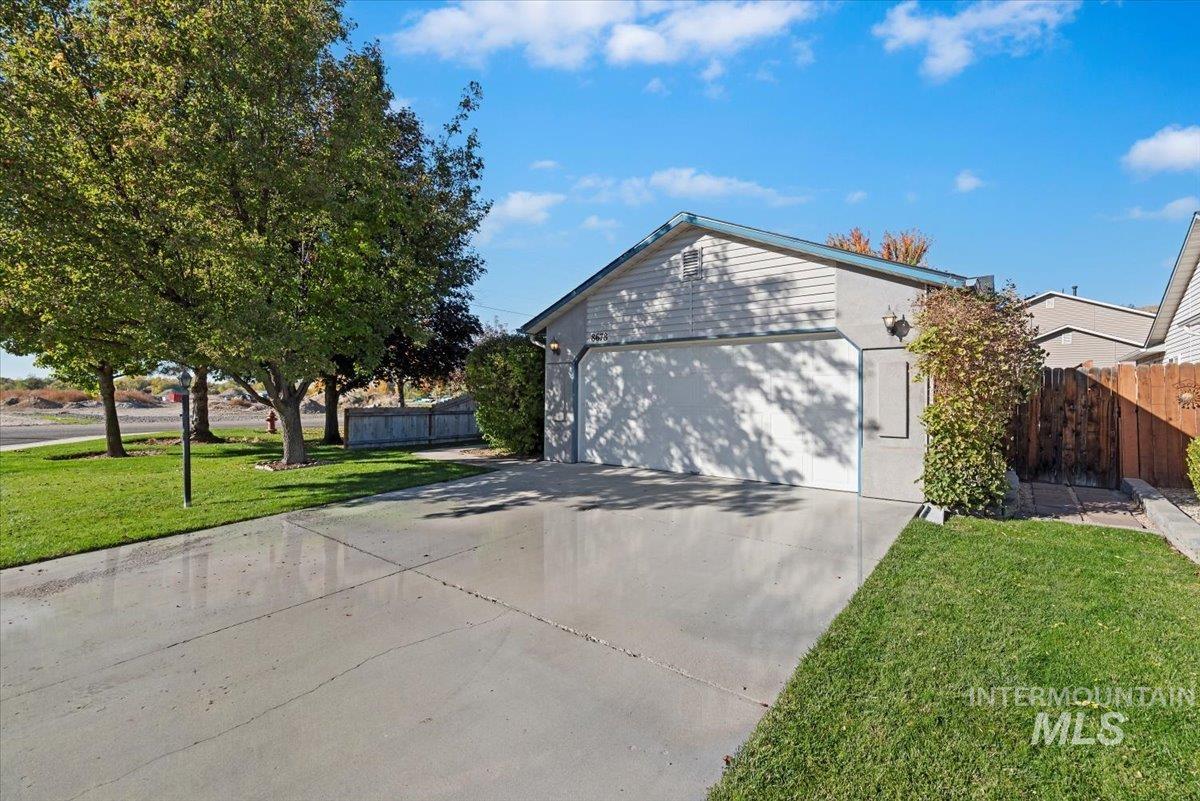 View of home's exterior featuring a garage and driveway