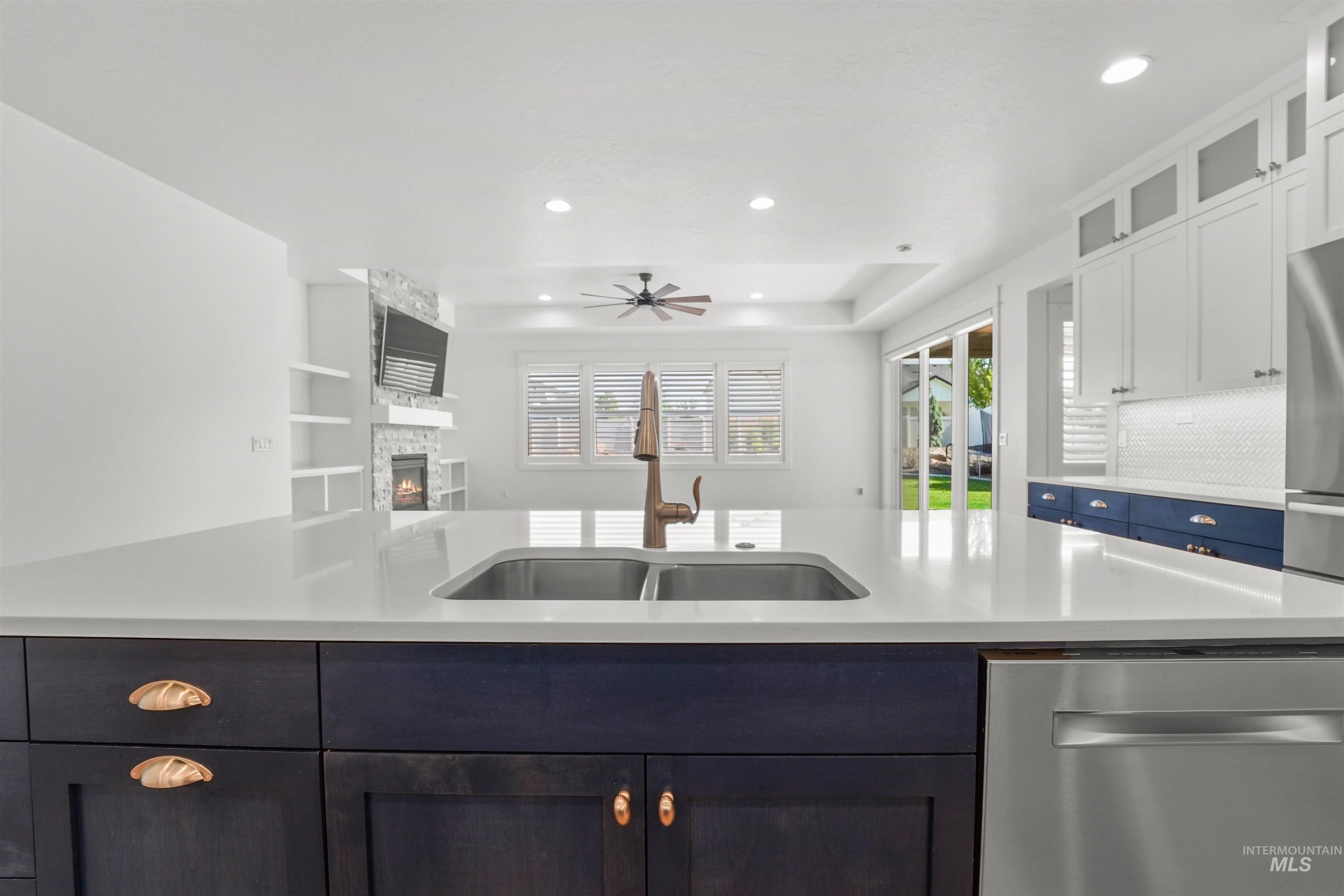 Kitchen featuring stainless steel dishwasher, light countertops, open floor plan, and recessed lighting