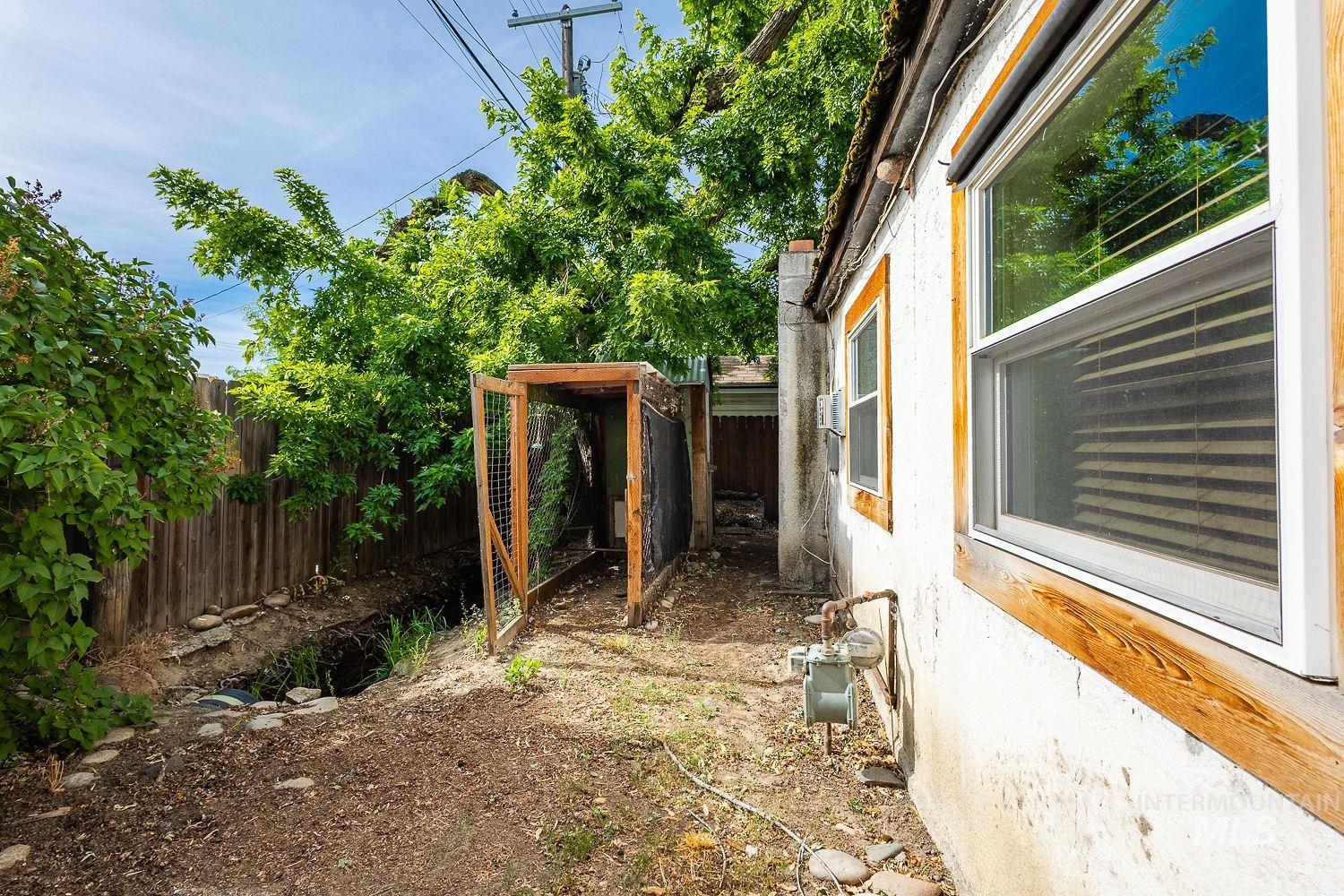 Exterior stucco wall with wood-framed windows