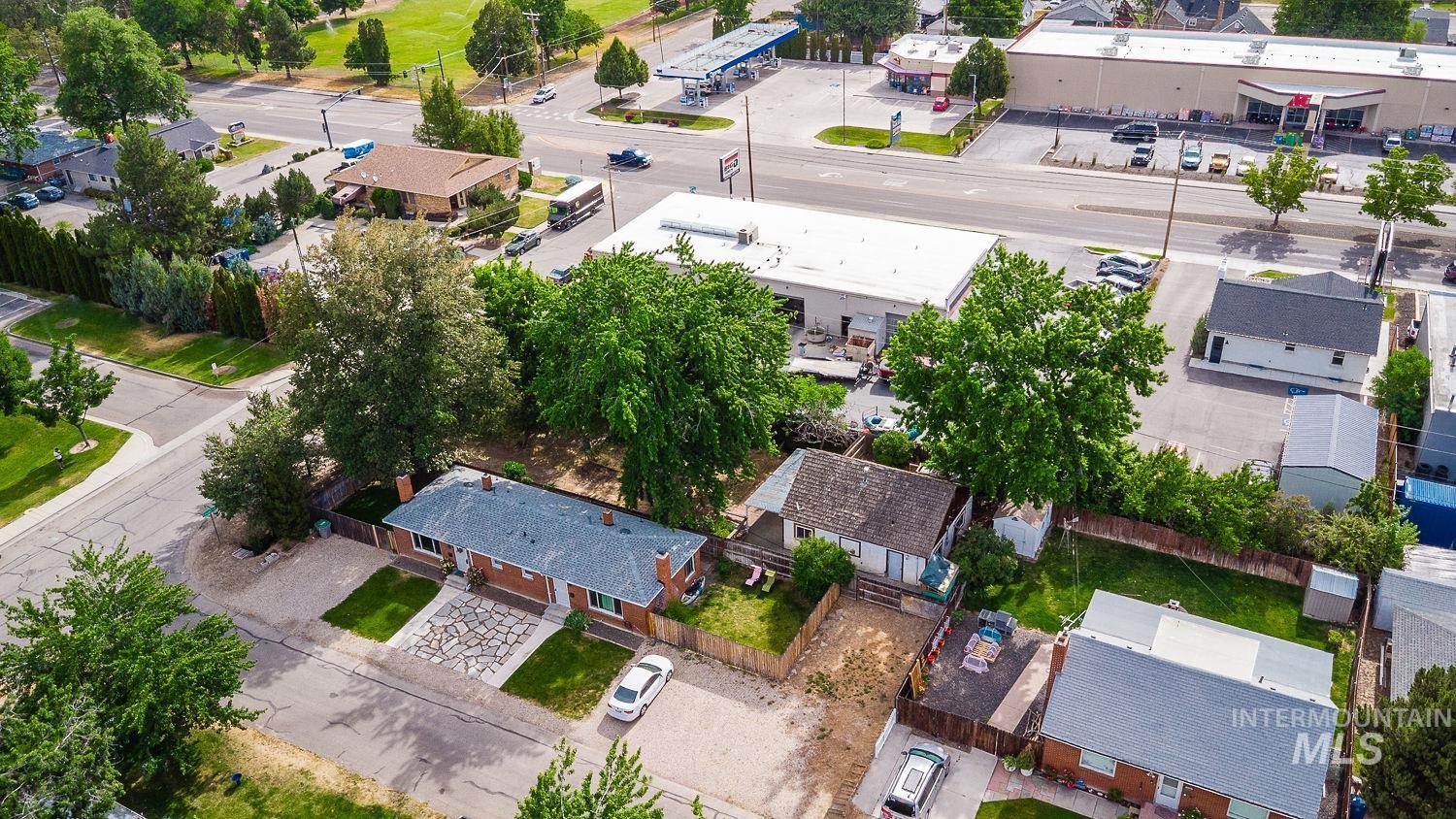 Aerial perspective featuring multiple residential structures situated among mature trees