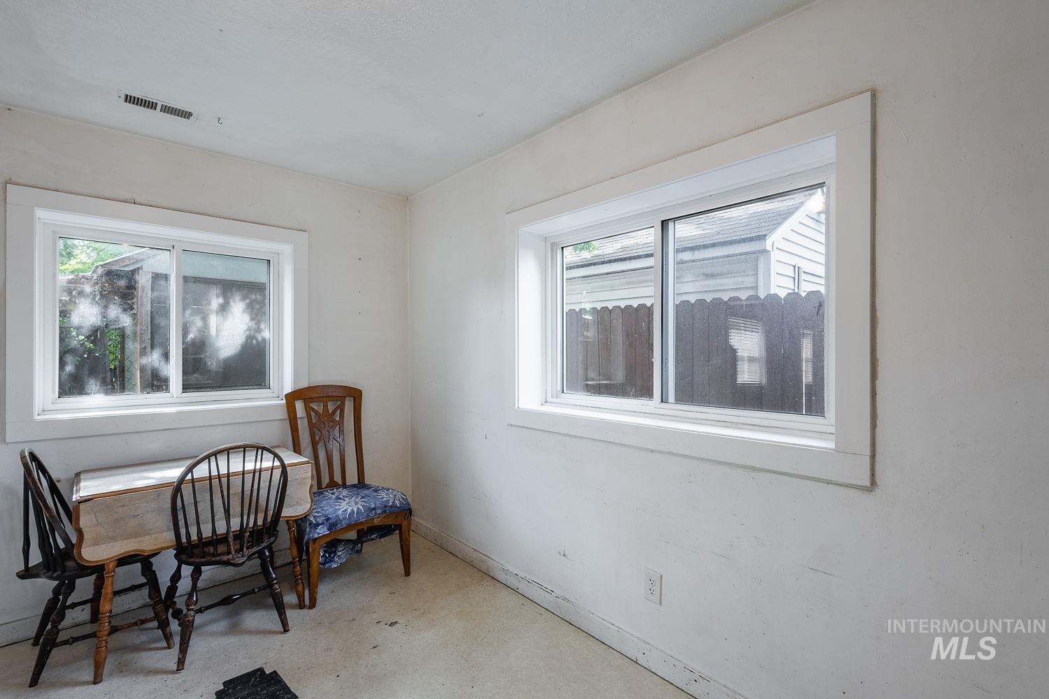 Bright room with two large windows featuring white trim and sills