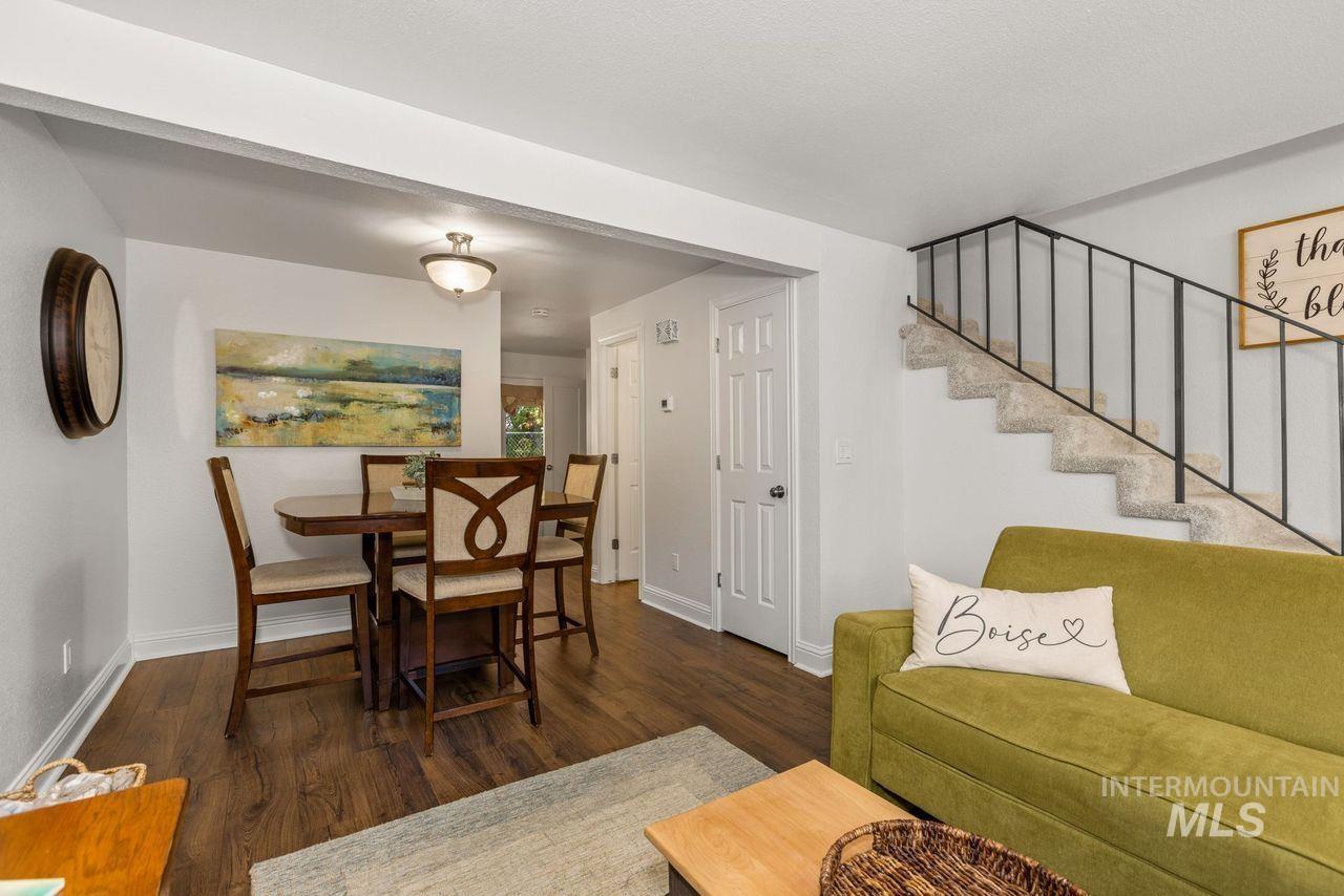 Dining room featuring wood finished floors and stairs