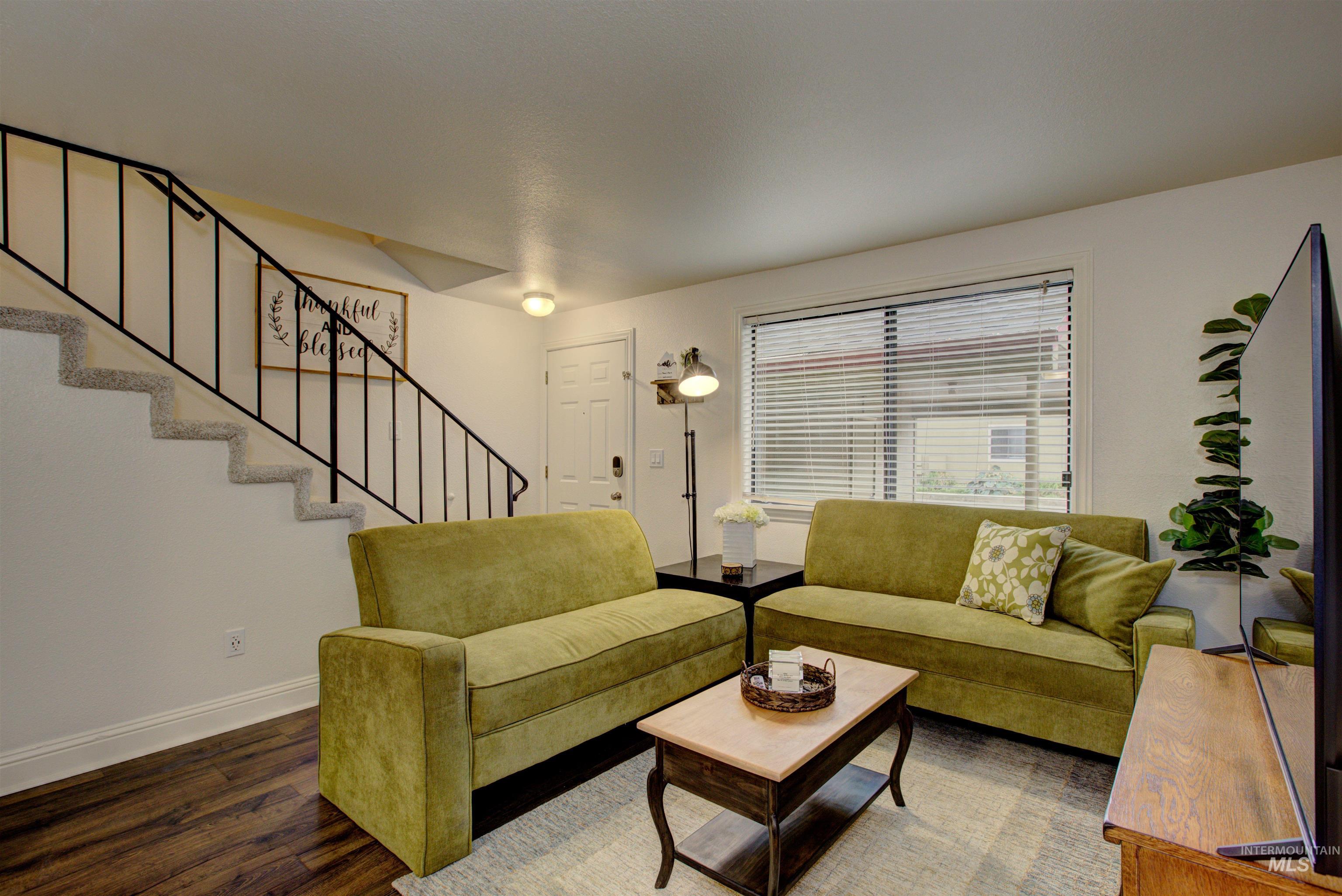 Living room with wood finished floors and stairs