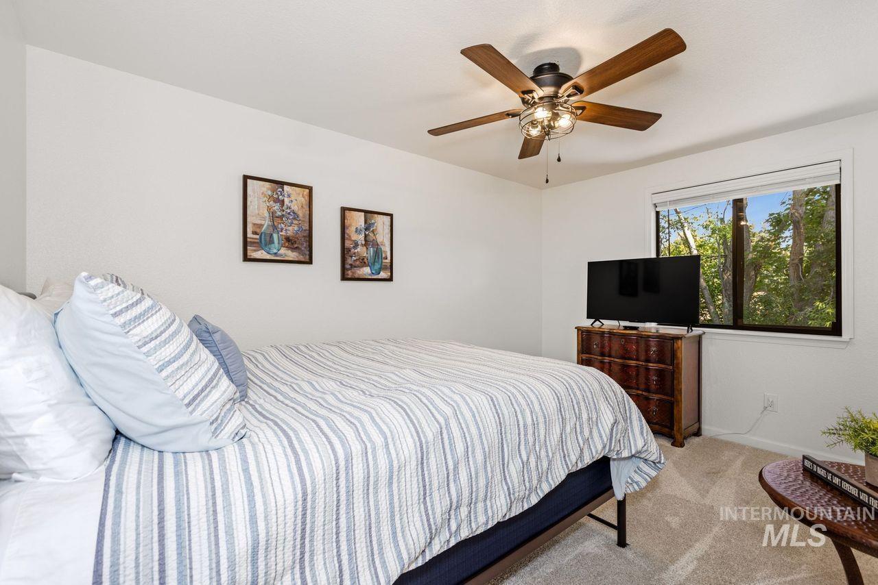 Bedroom featuring light carpet and a ceiling fan