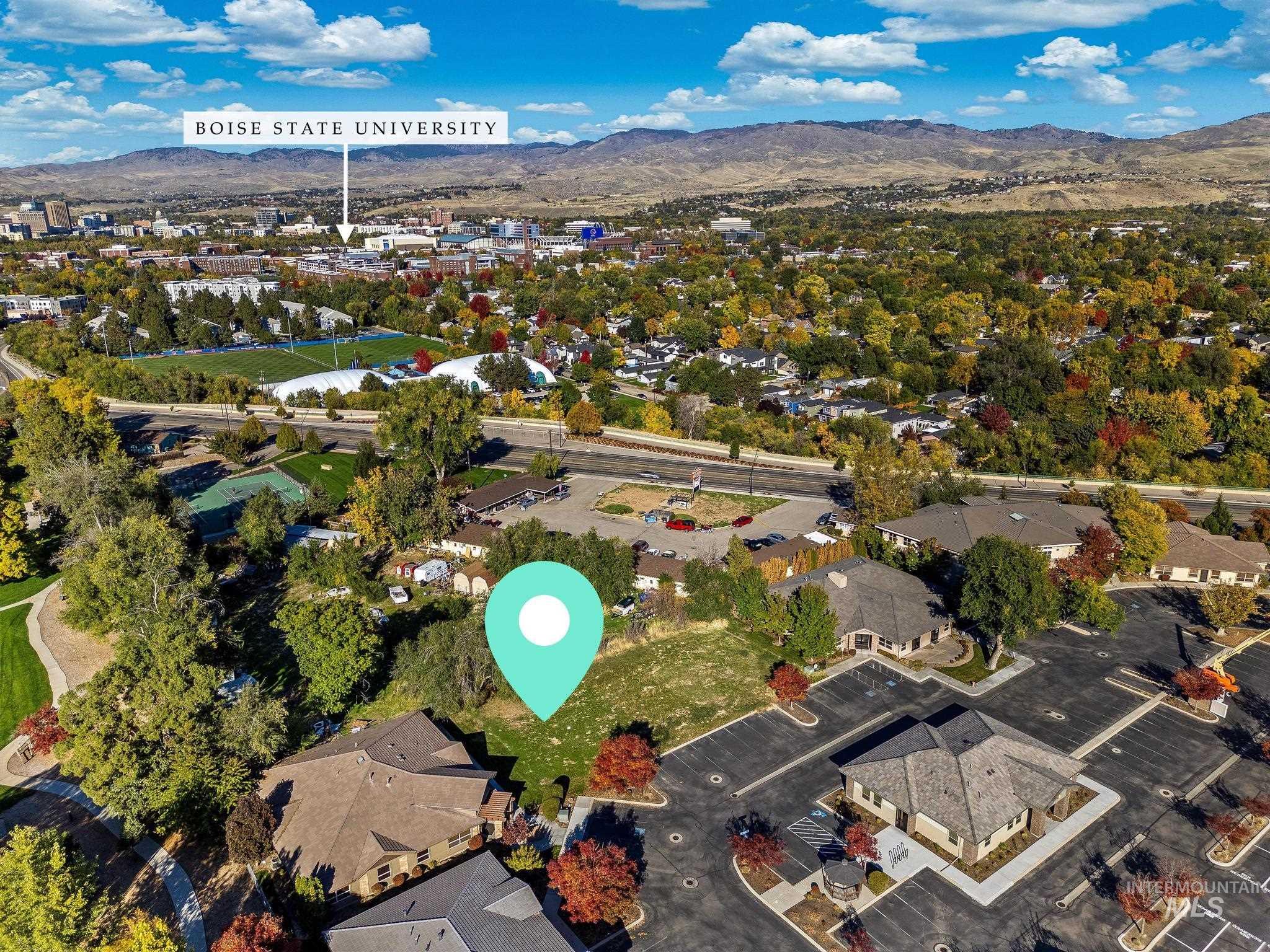 Aerial overview of property's location featuring a mountain backdrop and nearby suburban area
