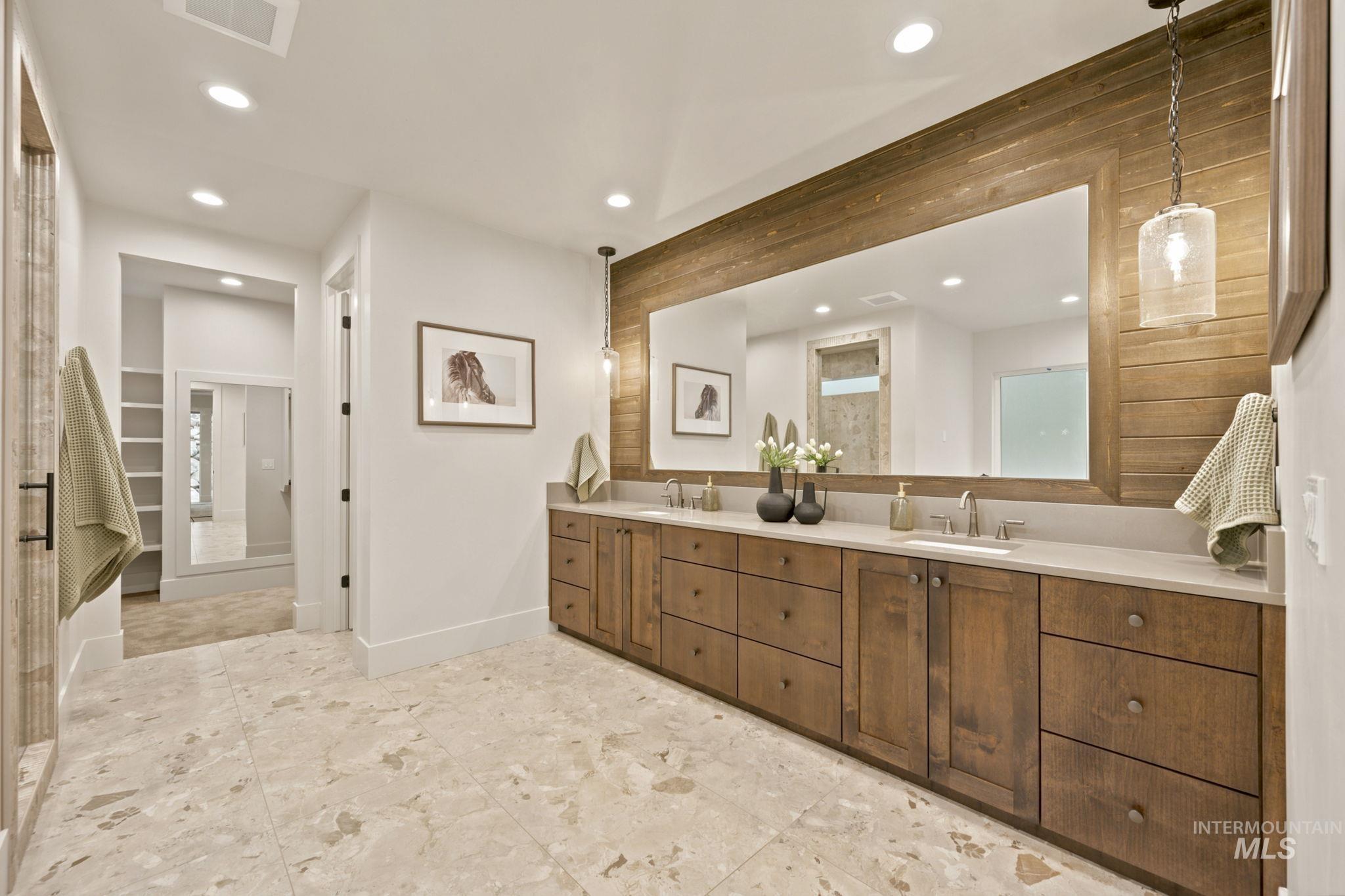 Expansive vanity with dual undermount sinks, light-toned countertop, and wood-finish cabinetry - Primary Second Floor