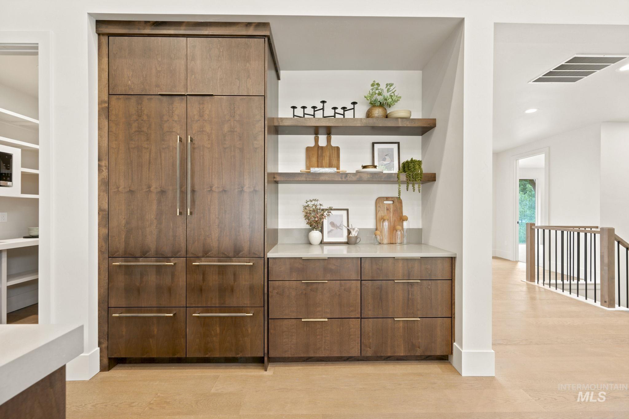 Integrated refrigeration unit and custom wood-finish cabinetry with linear hardware