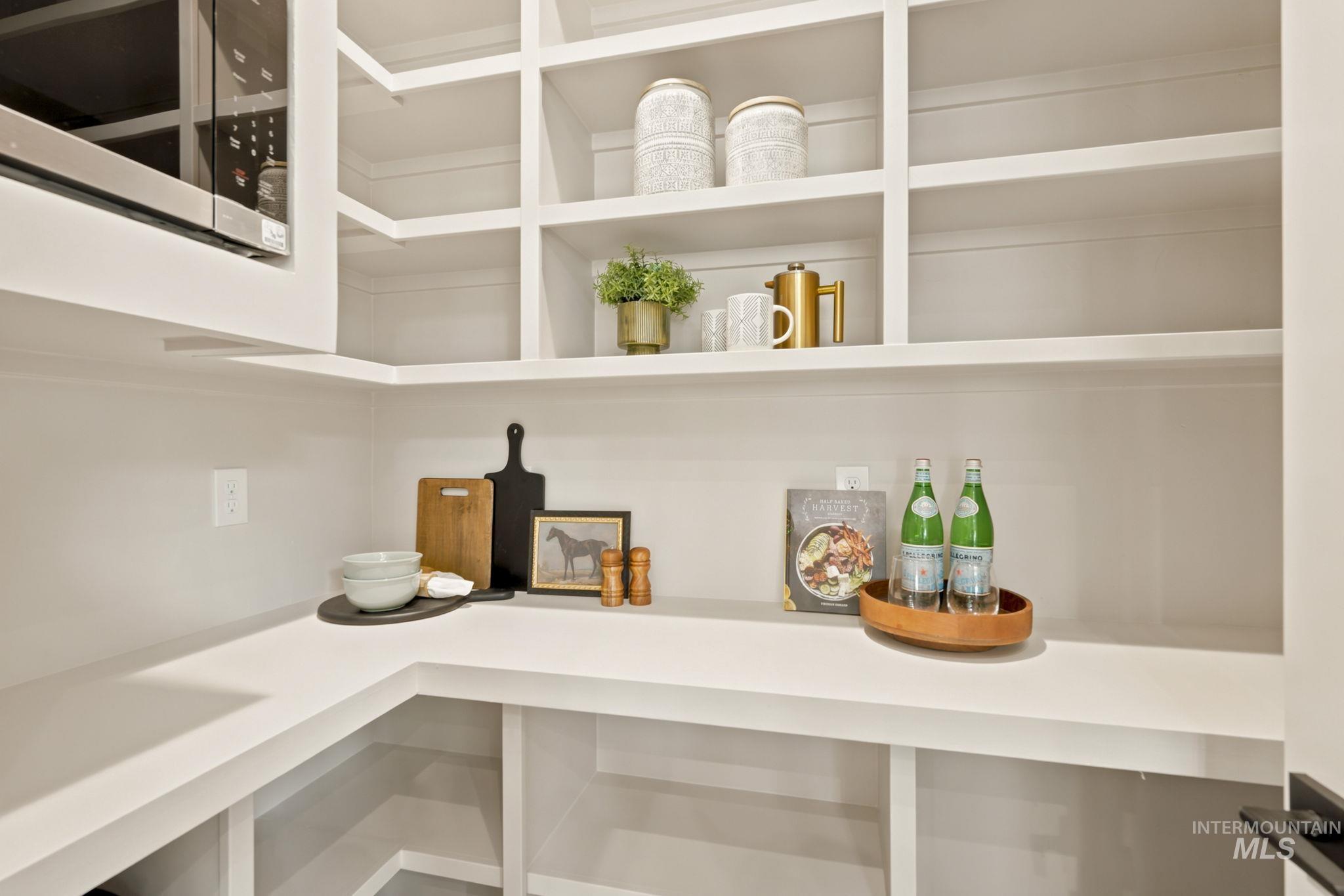 Built-in pantry system featuring extensive open shelving and white countertops