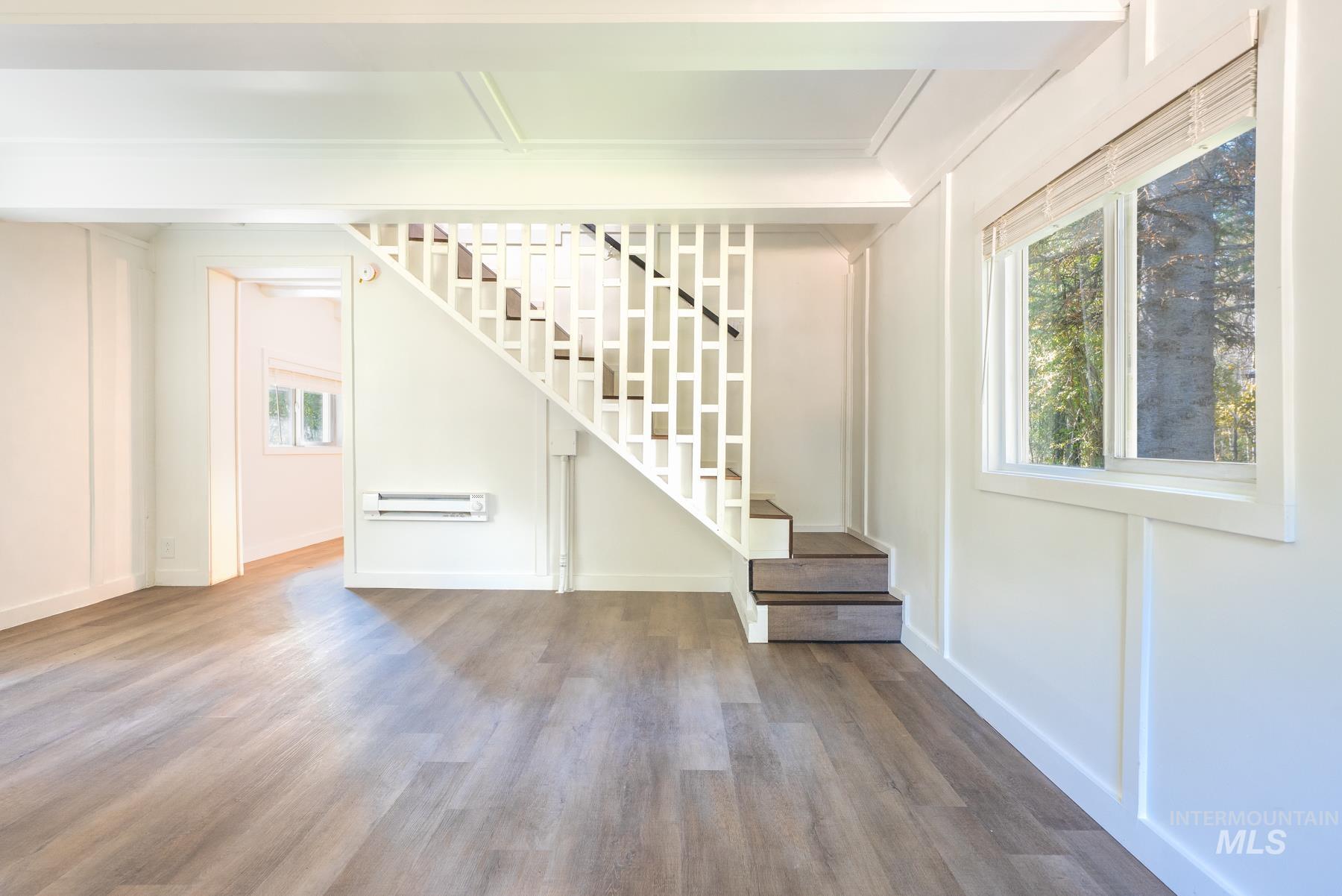 Entrance foyer with wood finished floors and stairway