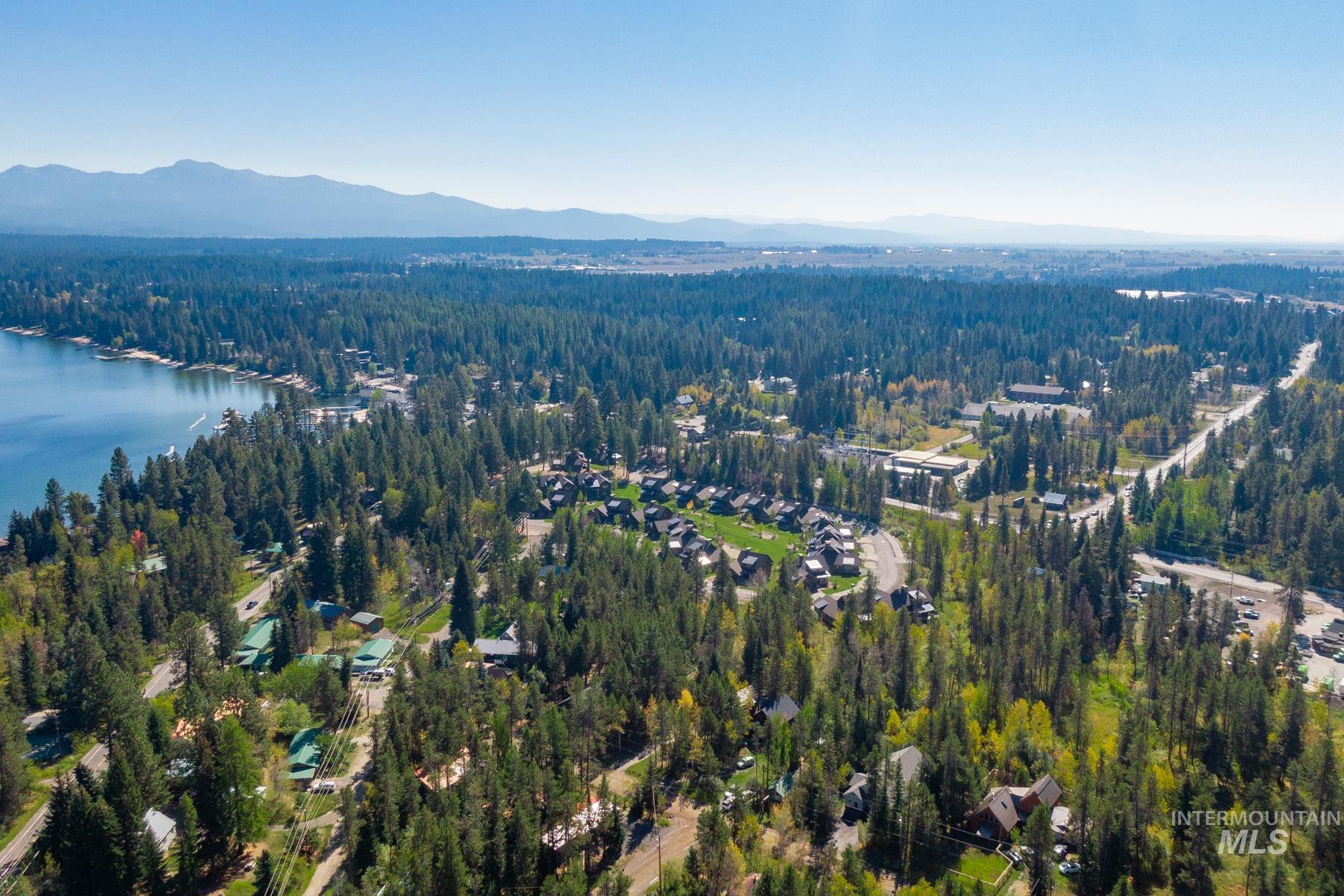 View of property location featuring a water and mountain view and a heavily wooded area