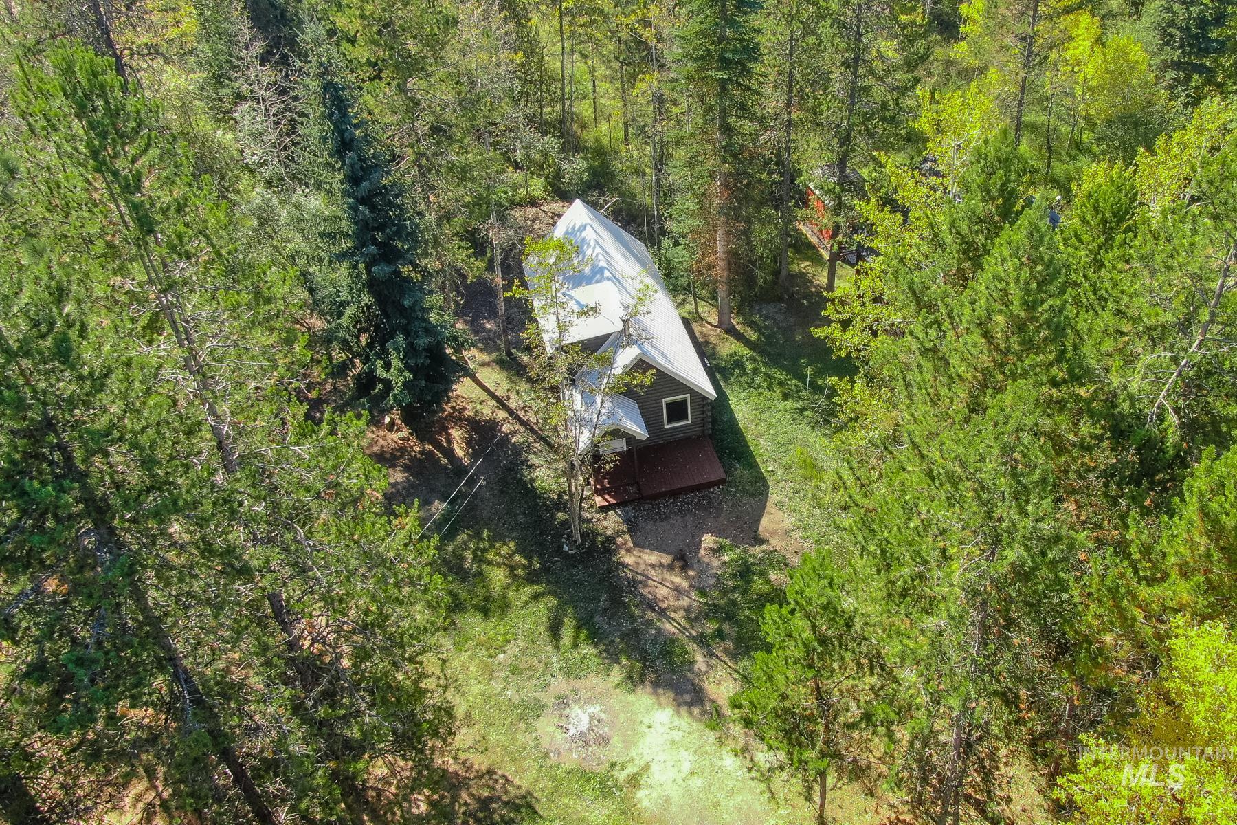 View from above of property featuring a heavily wooded area