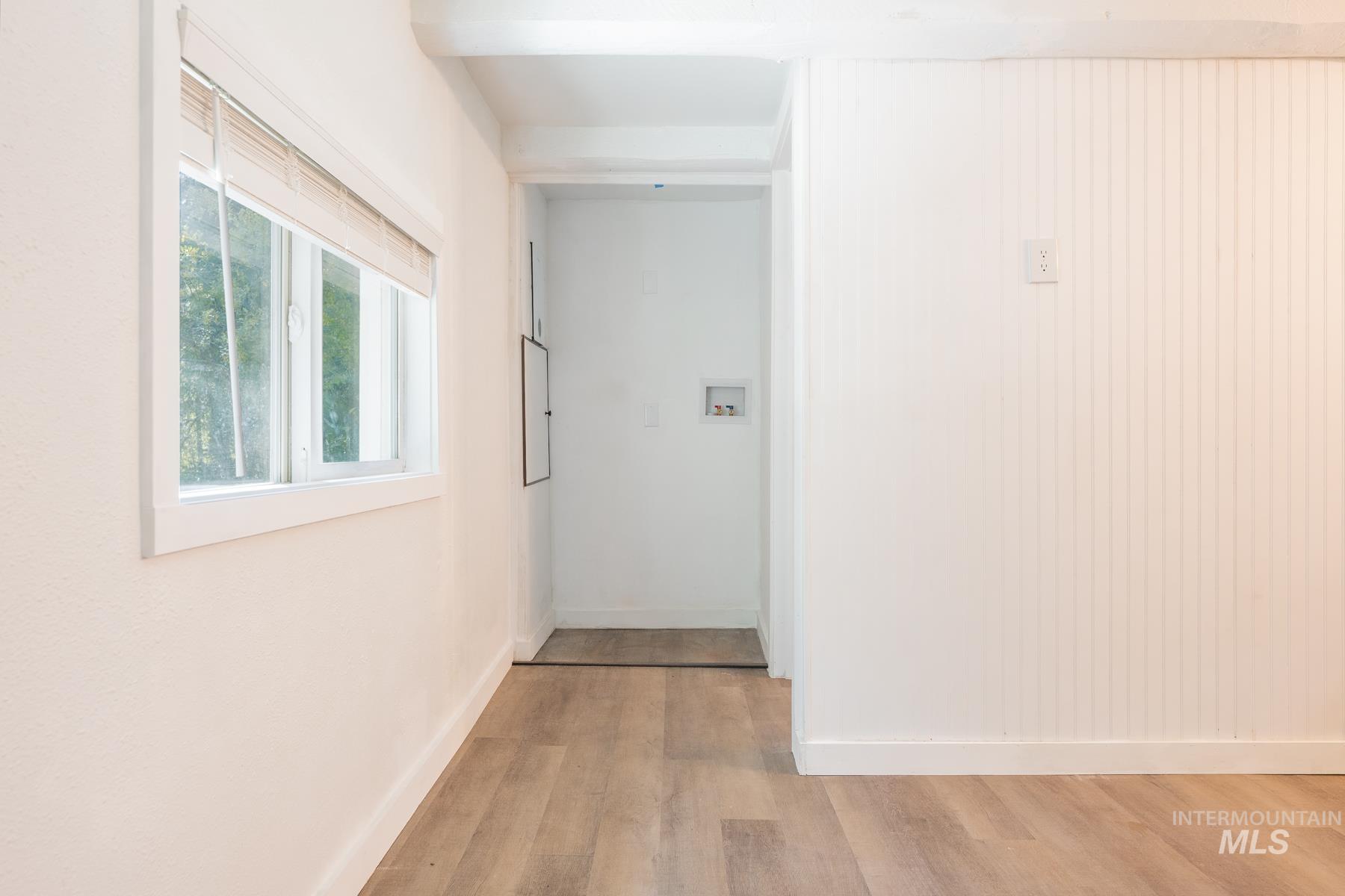 Hall featuring light wood-style floors and baseboards