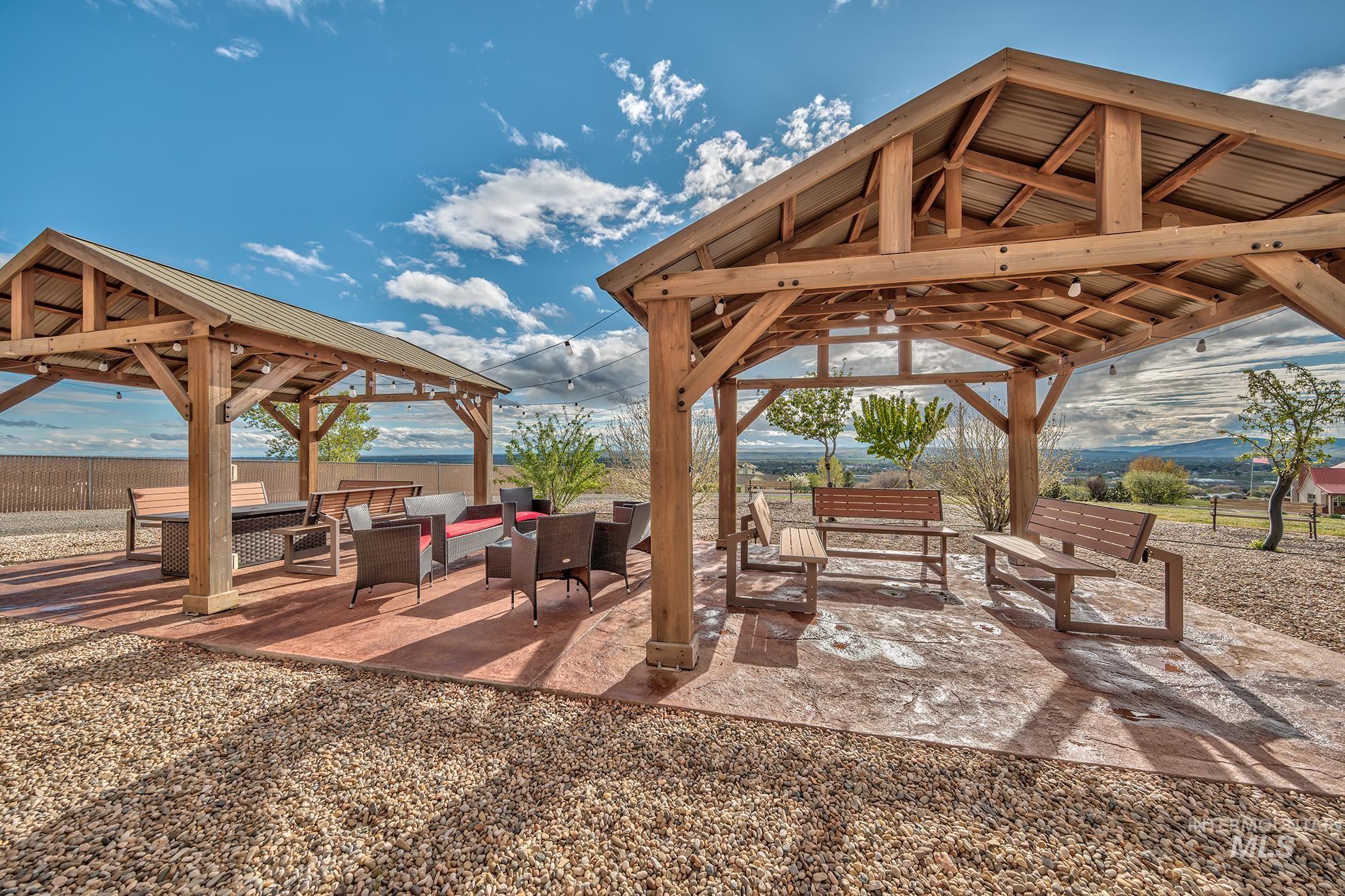 View of home's patio area and gazebos with outdoor seating